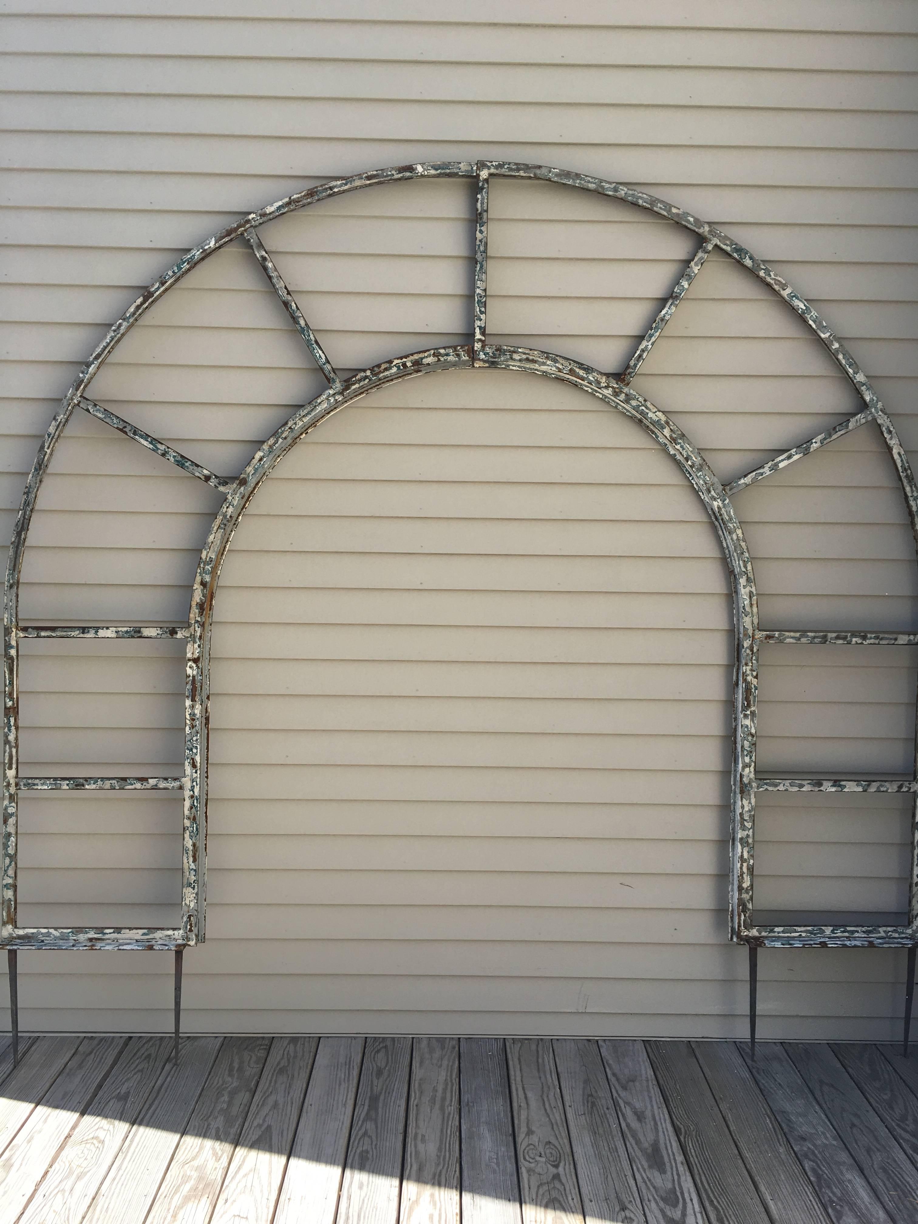 We have transformed this huge and very heavy painted steel window frame into an arched arbor or trellis that`s perfect for your climbing vines or roses. Impressive in scale and form, we have added four 14" long steel spikes to the bottom so