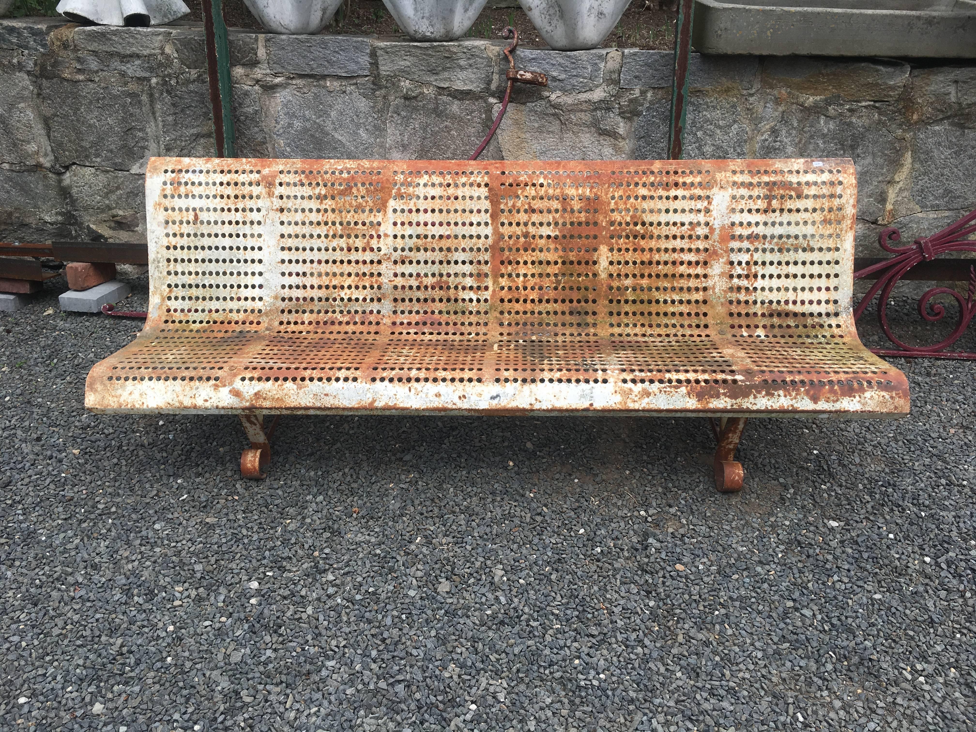 What a great example of French Mid-Century Modern design! Constructed of steel and with a beautiful lightly rusted patina with some original white paint showing through, this bench is the perfect complement to a contemporary garden. Commodious and