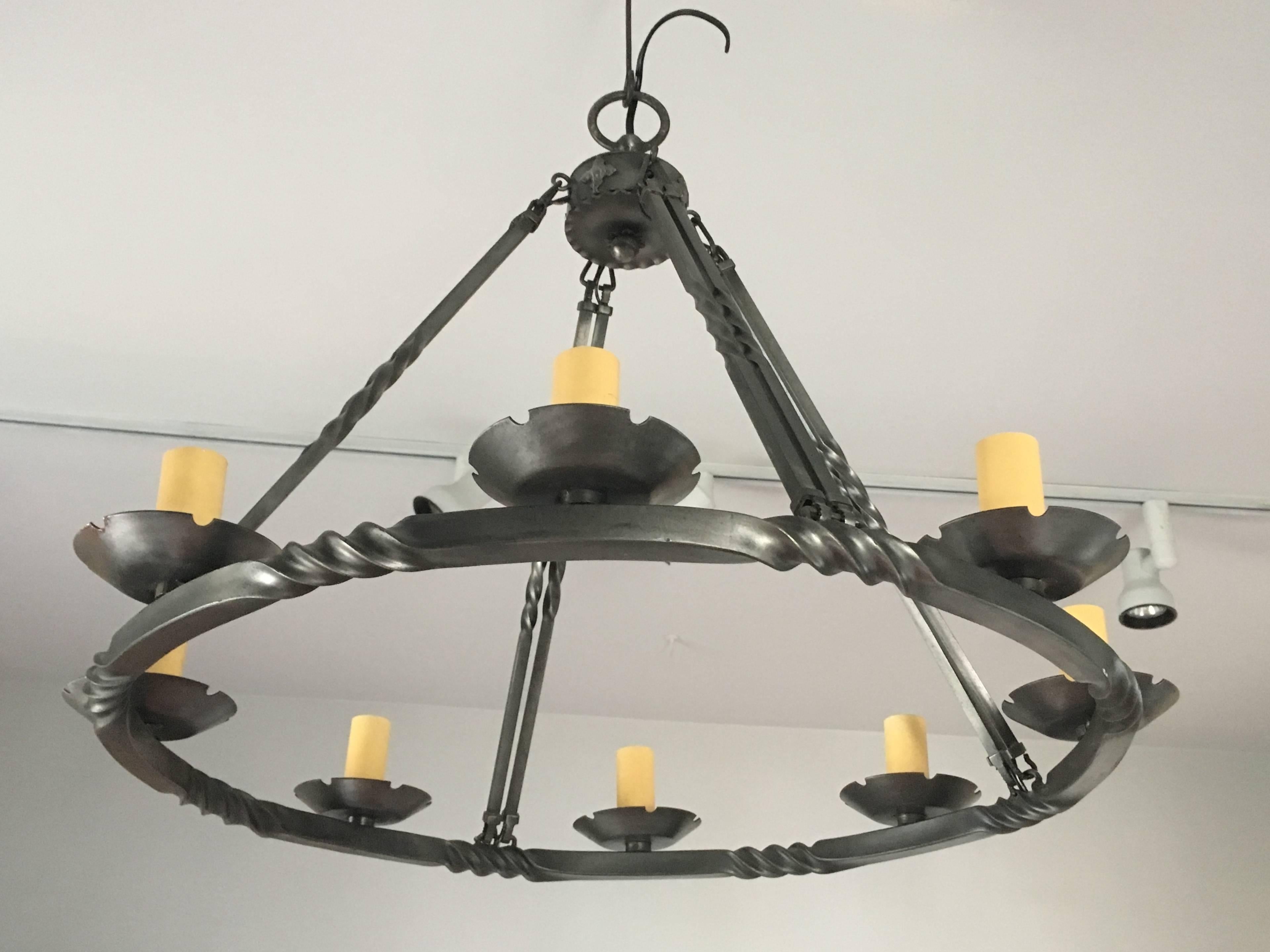 This contemporary polished steel chandelier will shine in any setting. With an unusual twisted rope design and eight sockets that accept regular-sized bulbs, it's the perfect piece over a contemporary dining table or in a kitchen with stainless