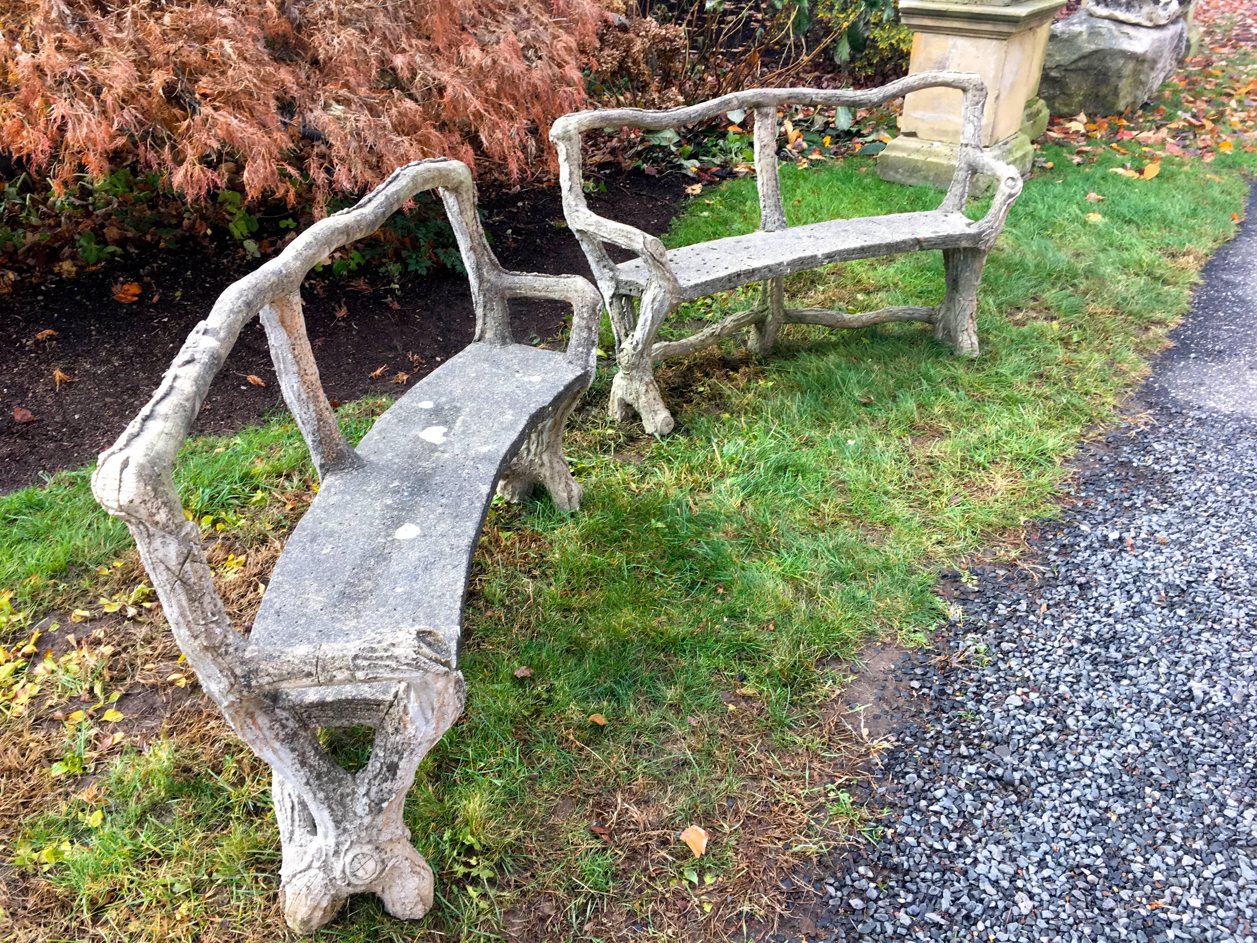 A very rare find, this pair of classical curved faux bois benches has a beautiful weathered surface with lichen and bits of moss. In perfect condition, they are so realistic that they have faux 