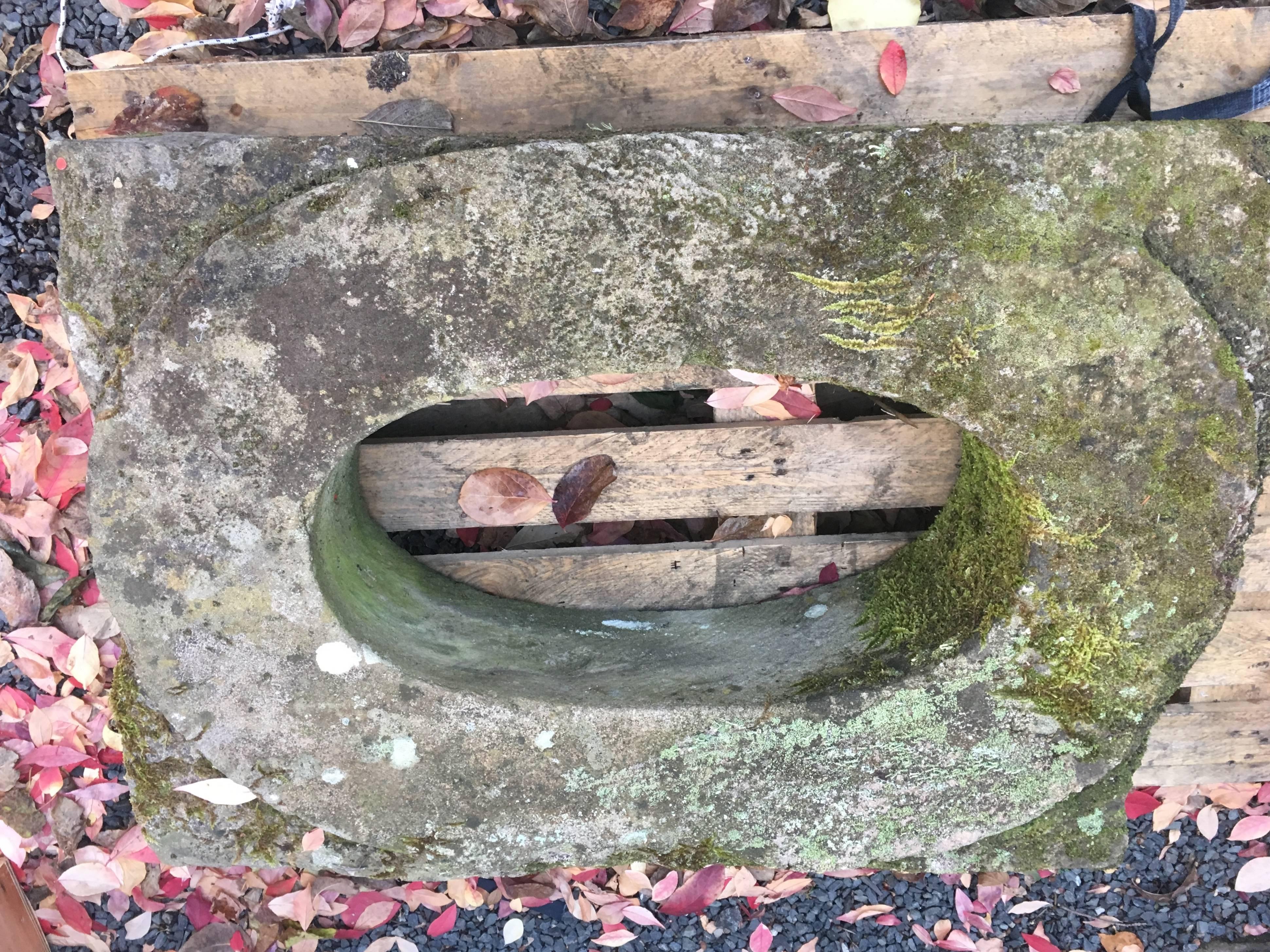 We are always in search of unusual objects to convert into sinks and this is the best we've ever found. Dating to the mid-18th century or earlier, this beautifully weathered oval-in-a-rectangle window surround was carved from a single block of stone