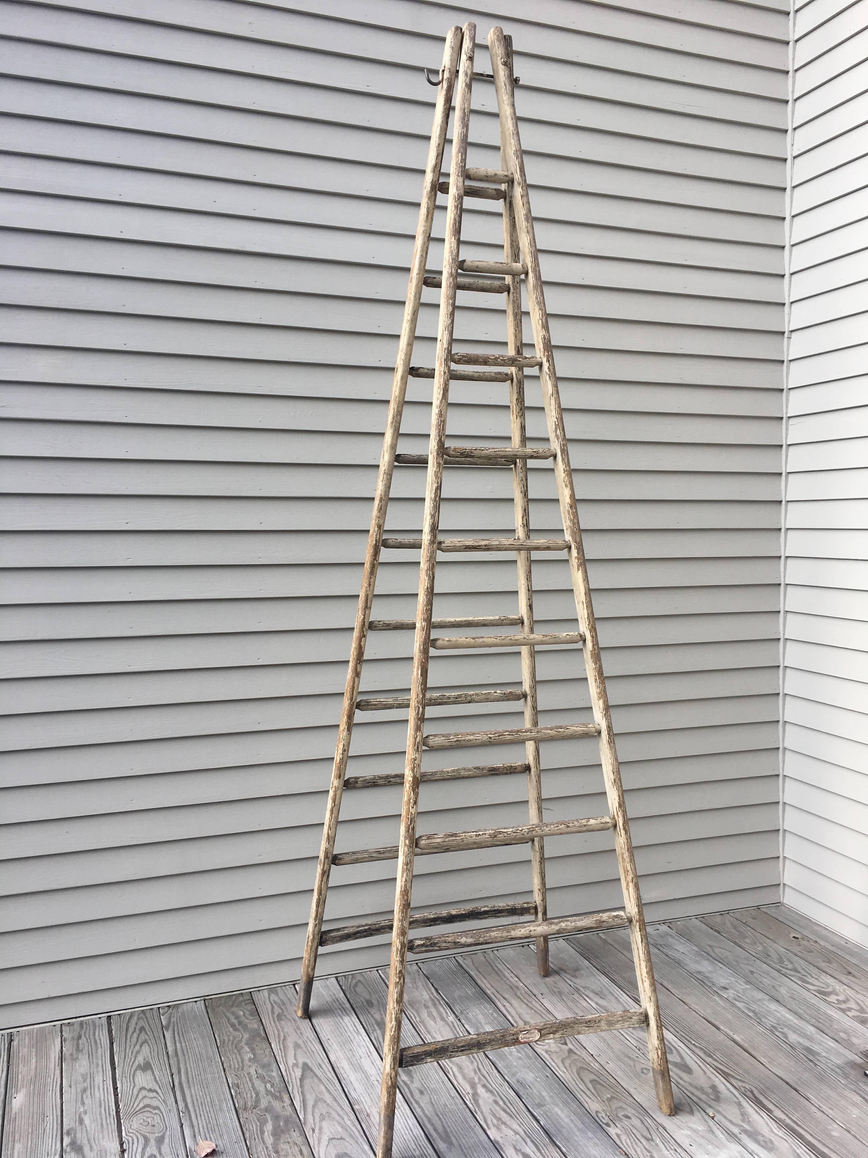 This very tall ladder is all handmade from oak and features traces of its original buttery-cream paint. It dates to the turn of the century and is in excellent condition. It would be perfect as a library ladder or as a towel rack and we can even