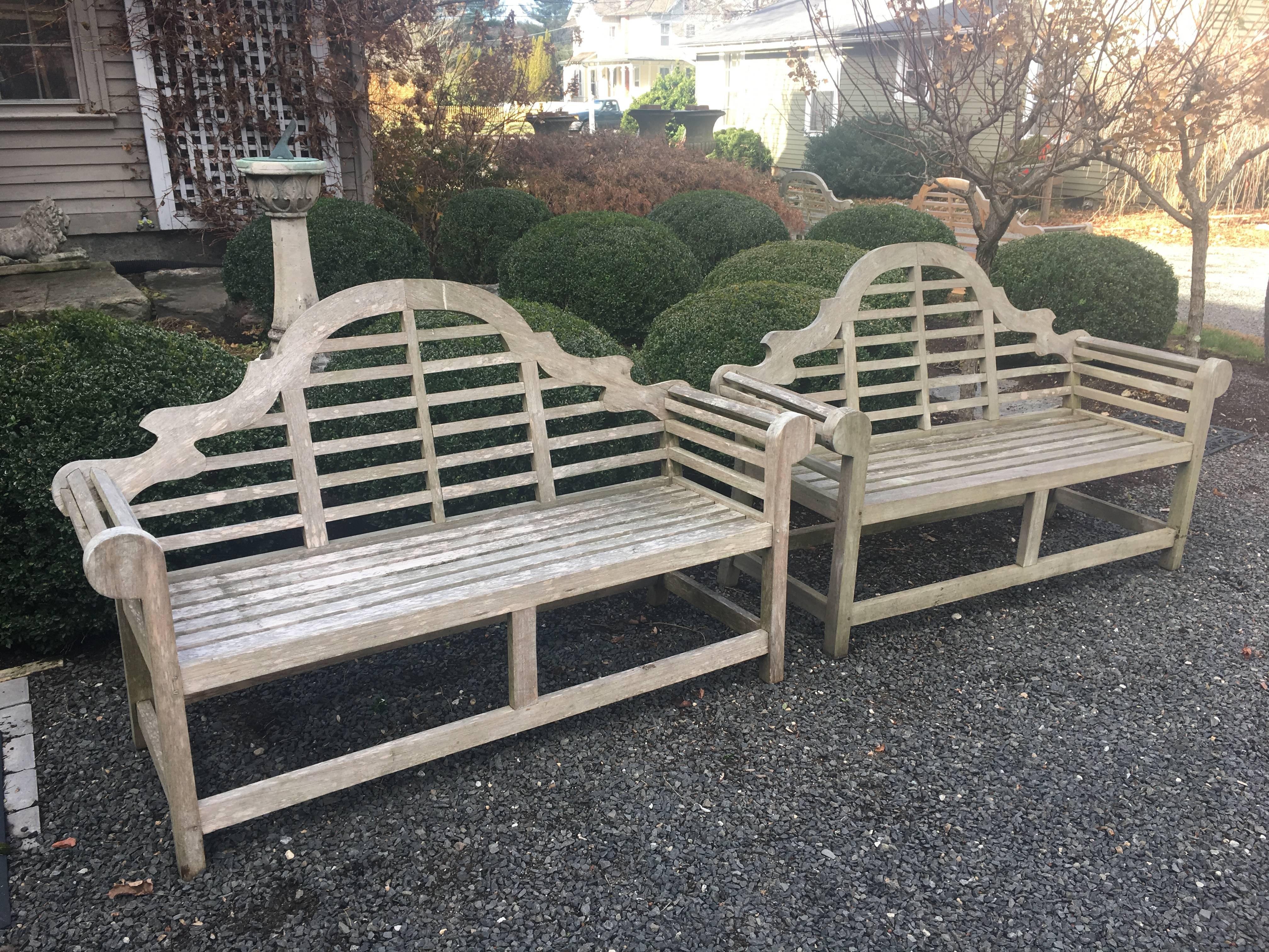 These classical teak benches, originally designed by the famous English architect Sir Edwin Lutyens in the early 1900s, have just enough age to boast a lovely silvered patina, but not so much as to impair their functionality. Perfect against an