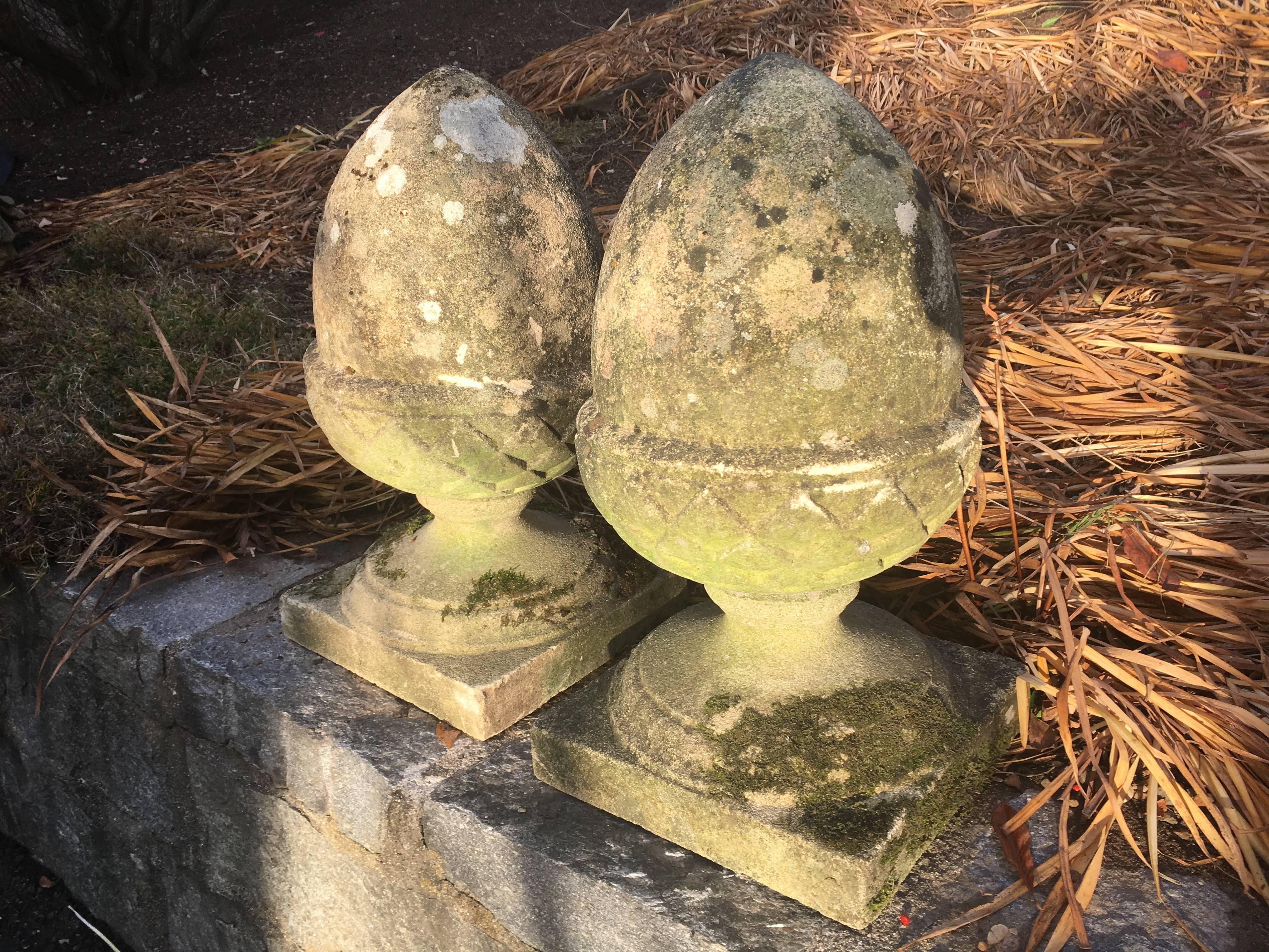 This Classic pair of English cast stone finials in the shape of acorns is beautifully-weathered and lichened and features lots of moss. Perfect flanking the top of a stone wall, on either side of your garden entrance, or on a mantel. In perfect