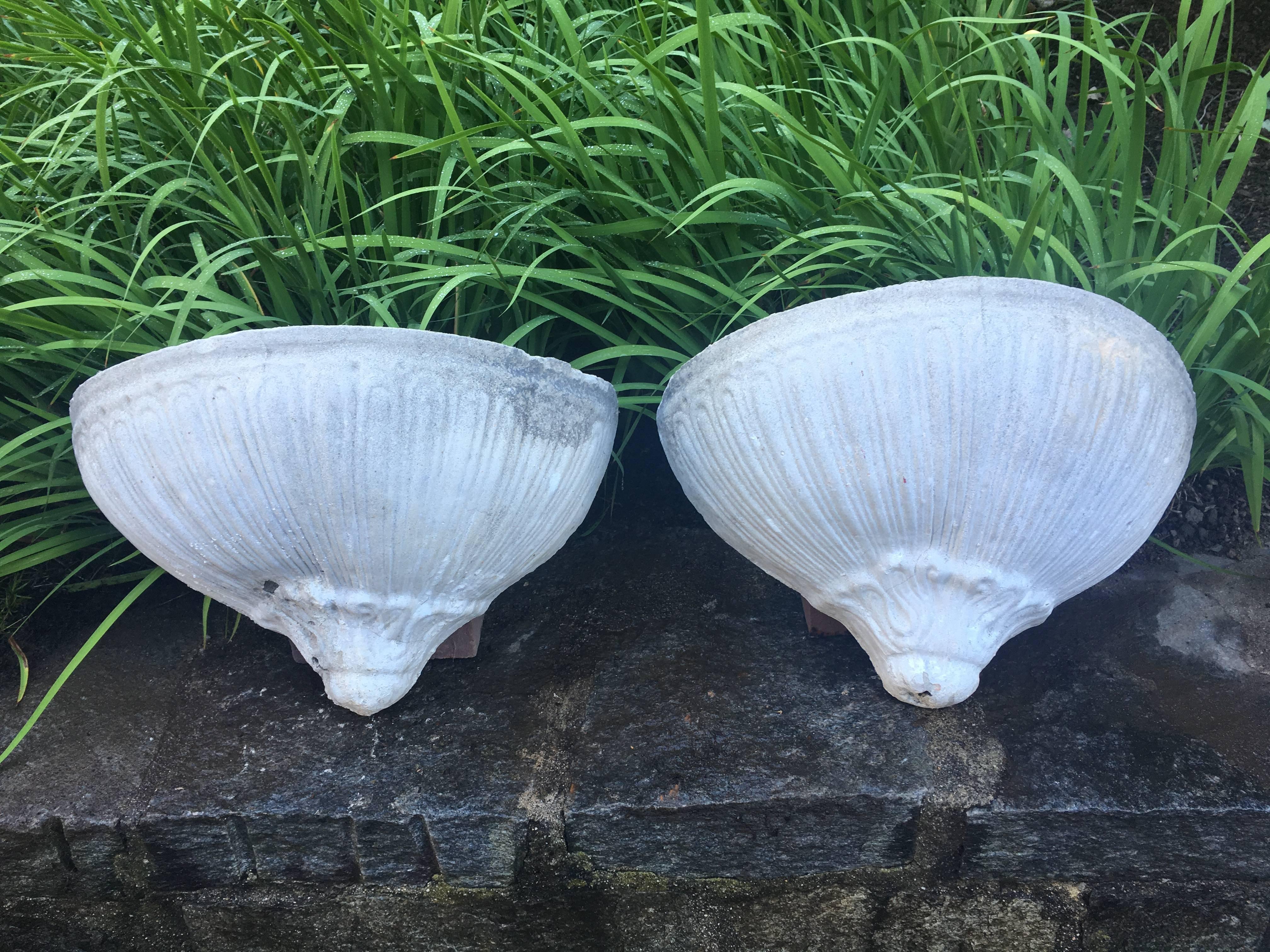 We love the unusual form of these white cast stone pocket wall planters and the fact that they can also be used as fountain masks. In very good overall condition, one has a small hole and two tiny ones on the front side, but nothing that detracts