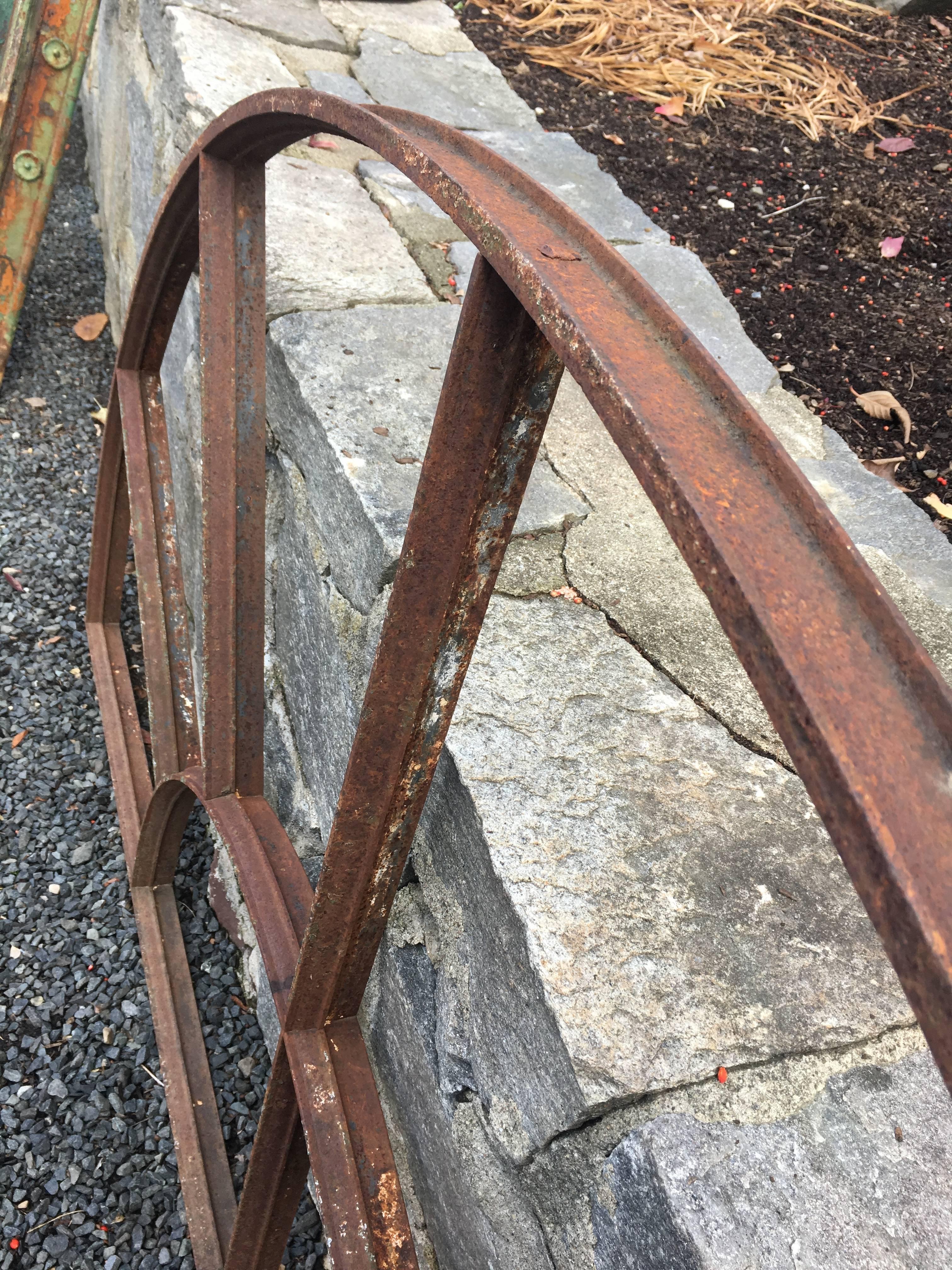 This grand and heavy wrought iron demilune window frame is perfect for a mirror or as a window in your new or renovated home or barn. Its large size is rare to find and it is in perfect antique condition. Originally from a mill in Norfolk, England,
