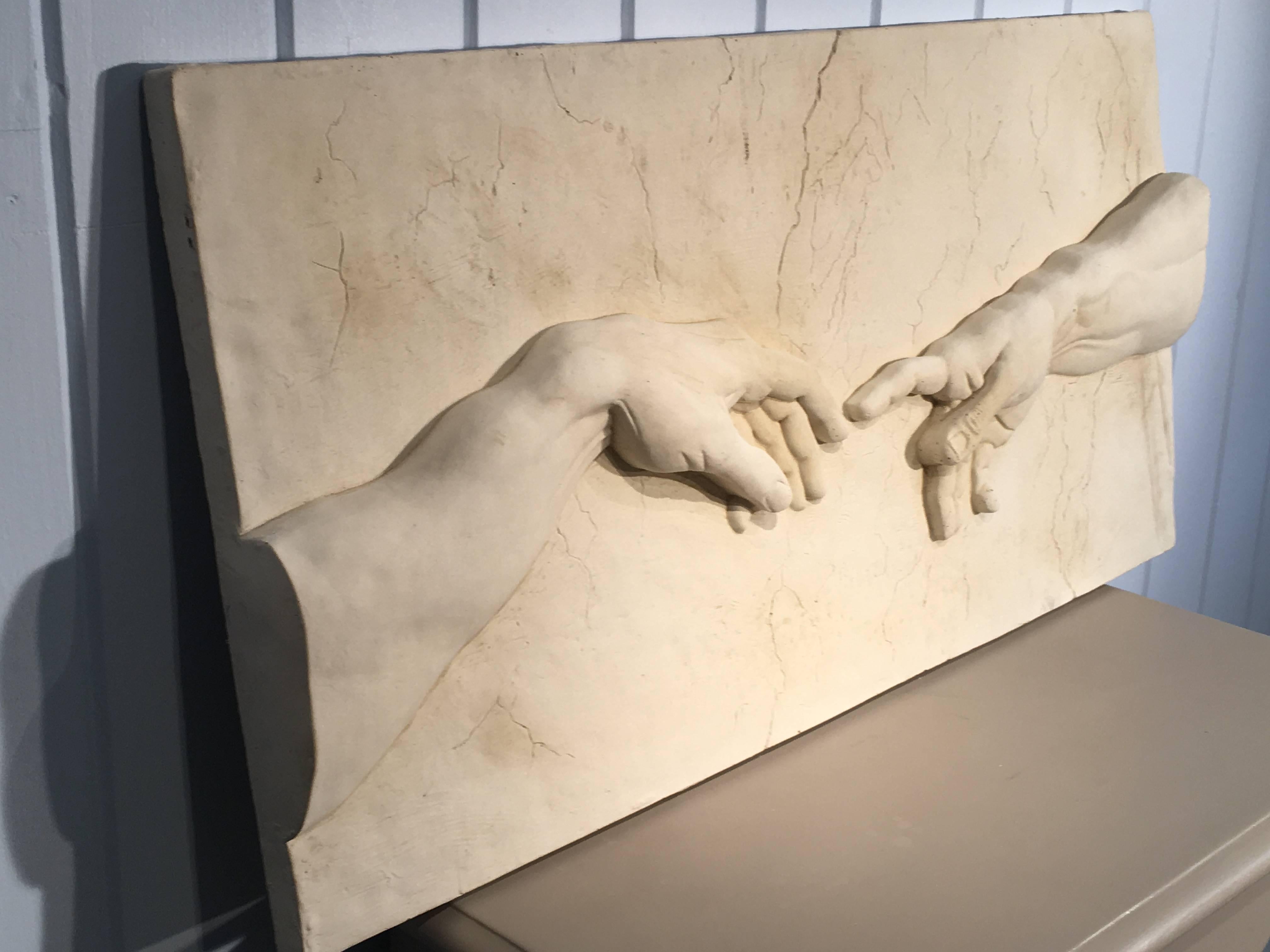 This large and impressive cast stone plaque is a contemporary twist on the Creation of Adam by Michelangelo and wonderfully executed. Beautifully-cast with impressive bas relief, it has built-in hanging loops on the reverse and can go indoors or