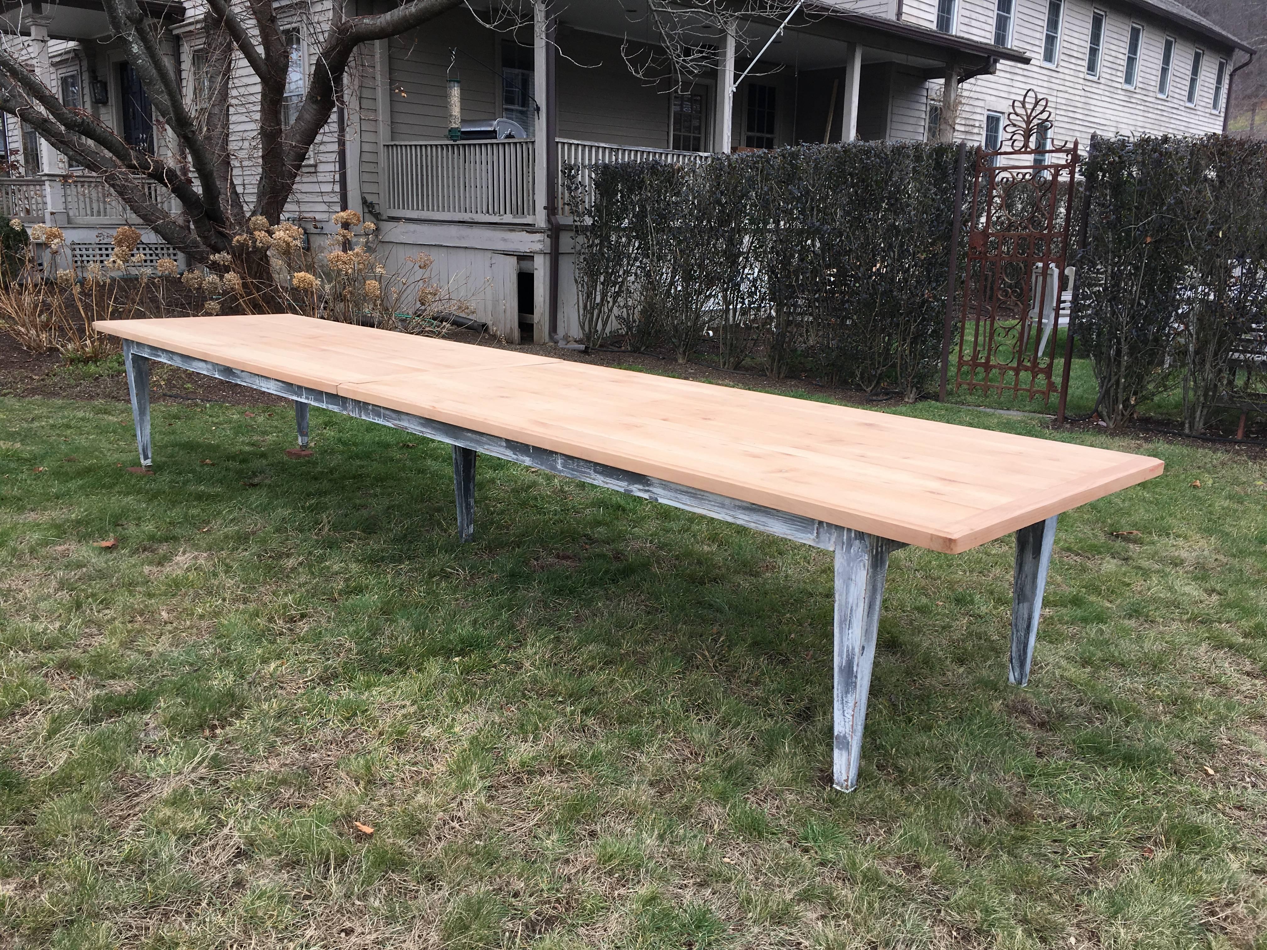 Now here's 16+ foot log table that will do any large dining room proud! Made of red oak with decorative brass banding on the bottom of the legs, it has an ingenious sliding mechanism that allows it to be dissembled into two parts for shipping. When