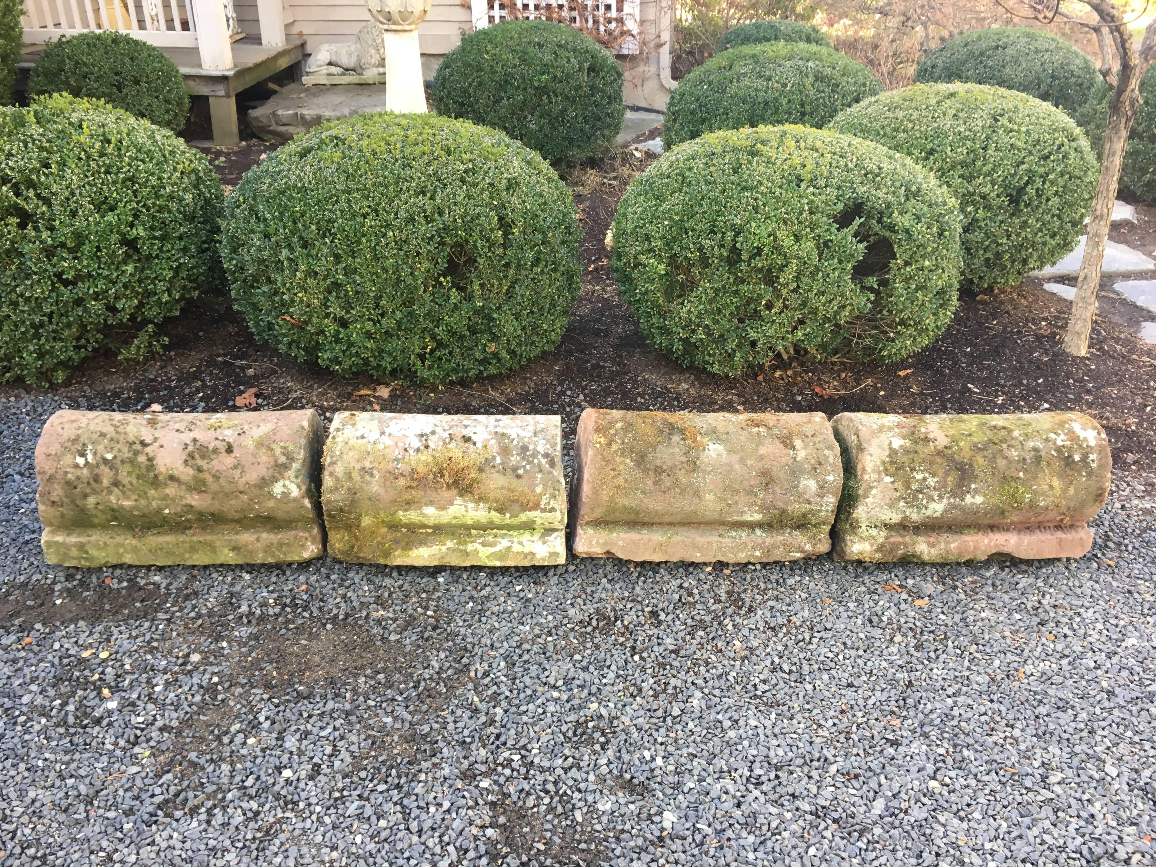 We found this set of four hand-carved pink sandstone curb stones in Northern France, covered in moss and lichen and begging to come to the U.S. They look marvelous placed end-to-end or spaced with short runs of low hedging in between them.