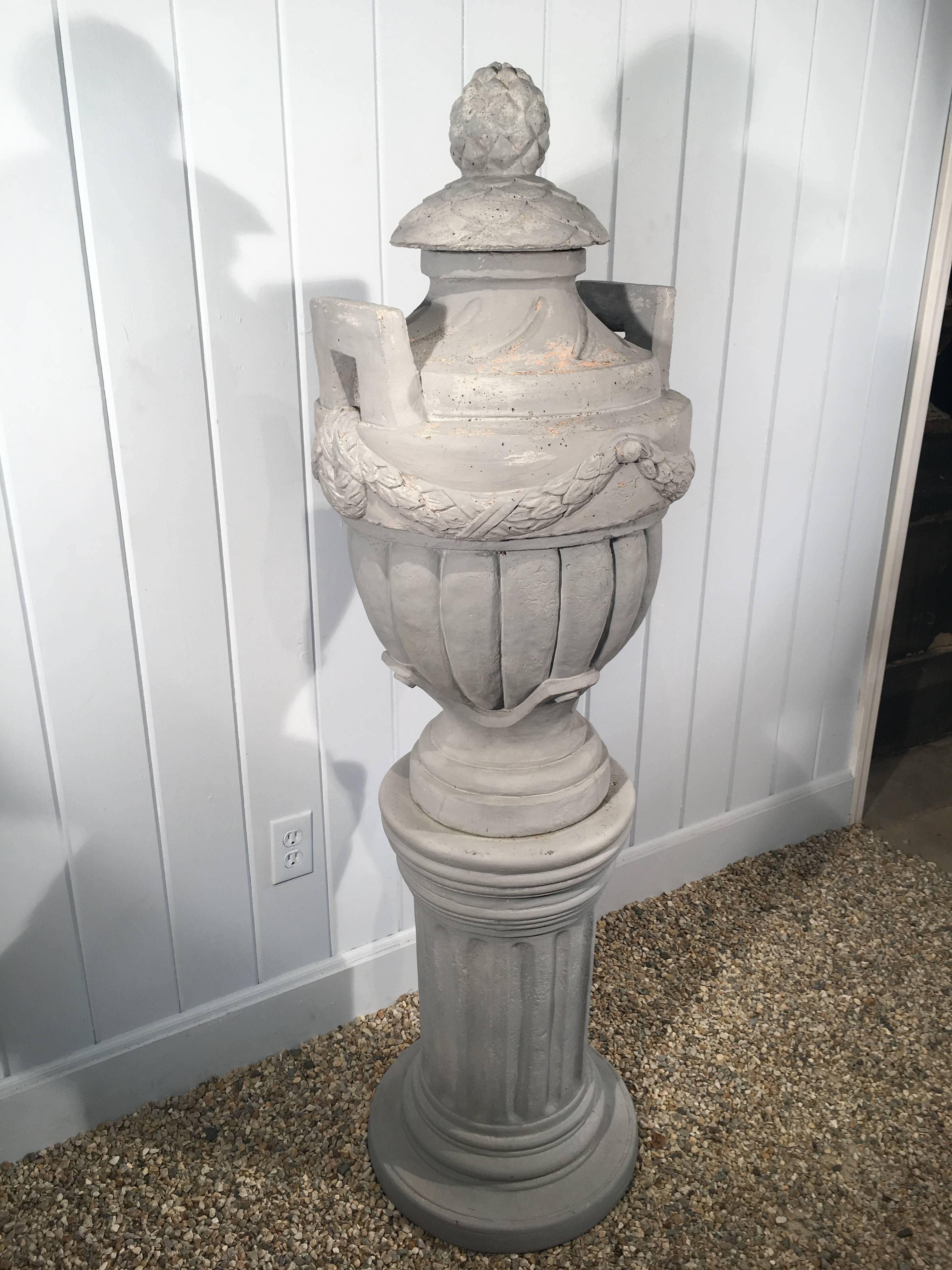 We bought these two pieces separately and, after painting their unattractive red surfaces in a pale grey, they make a fabulous statement together. The English cast stone Greek-style urn breaks down into 4 pieces for easy shipment and the fluted