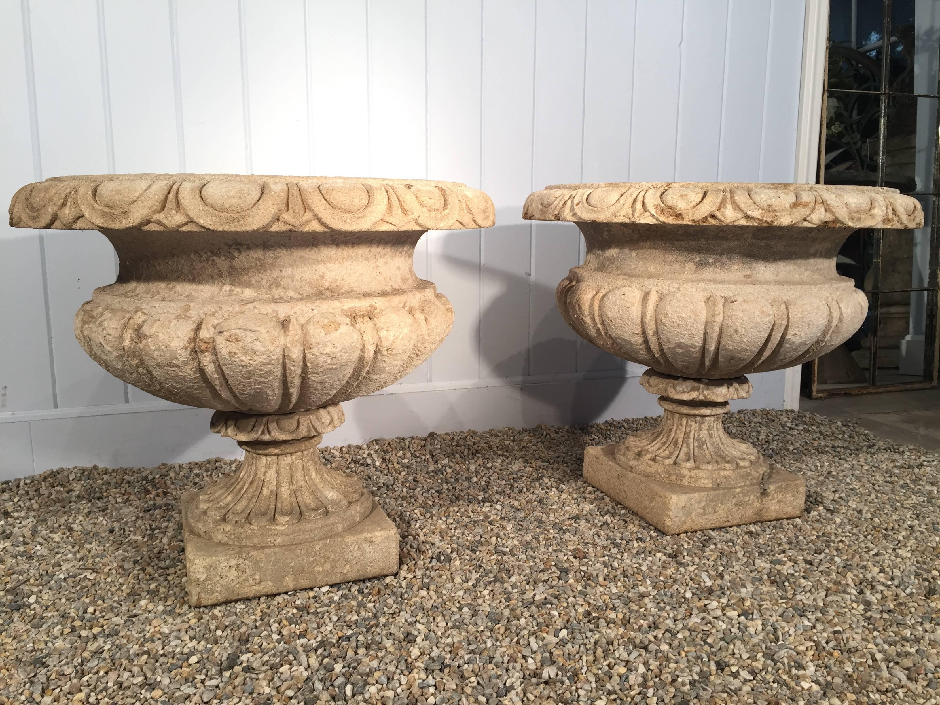 These very beautiful and large hand-carved limestone urns are real showstoppers! They came from the former estate of Michael and Diandra Douglas in Beverly Hills and we believe them to be late 19th century and of Italian origin. One pair is in