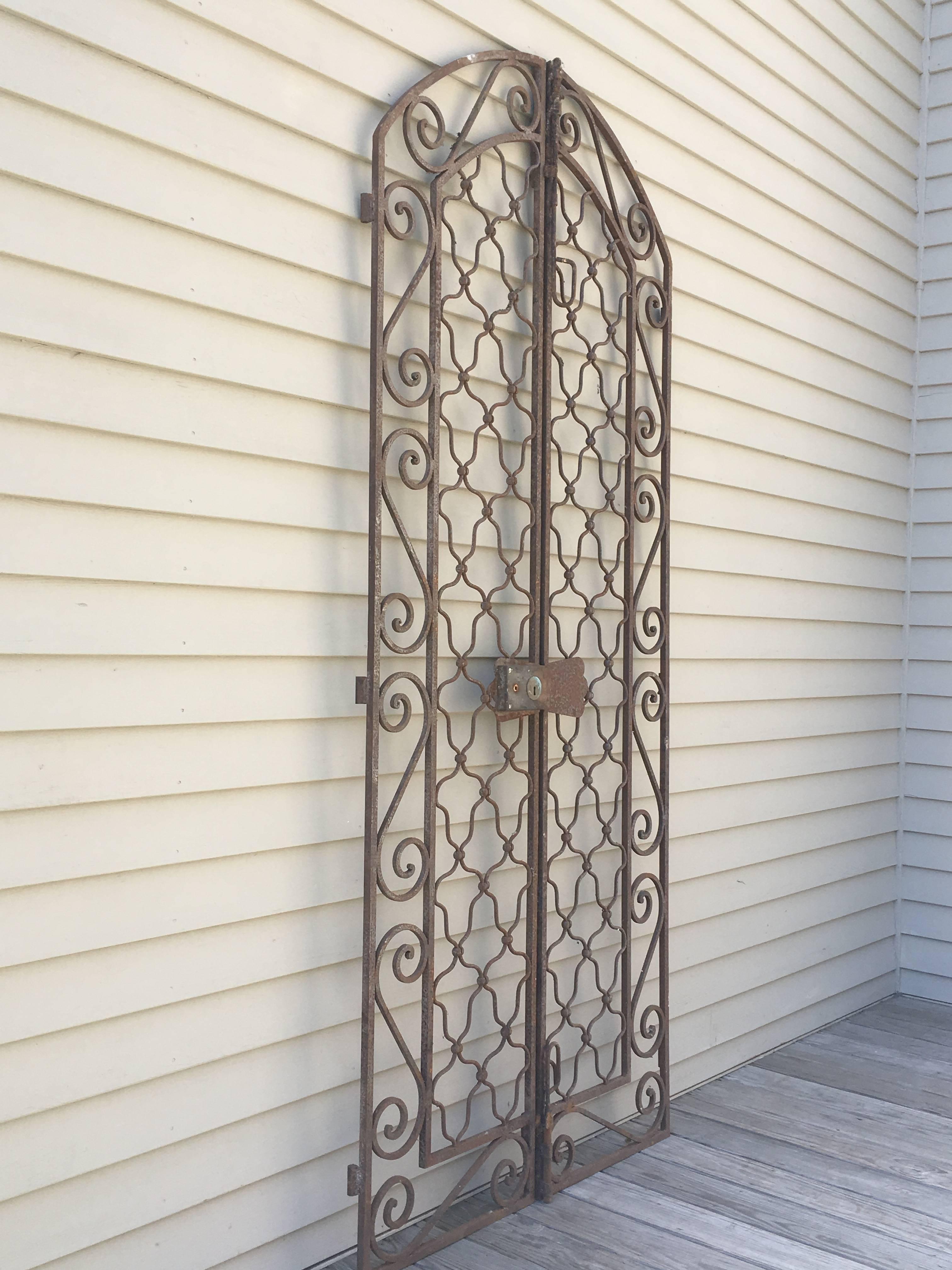 This stunning pair of gates were found in Provence and would make a beautiful entrance to your secret garden. At just over 90 inches tall, they feature their four original hinges and are in lovely, albeit rusty, condition. The doorknob and latch do