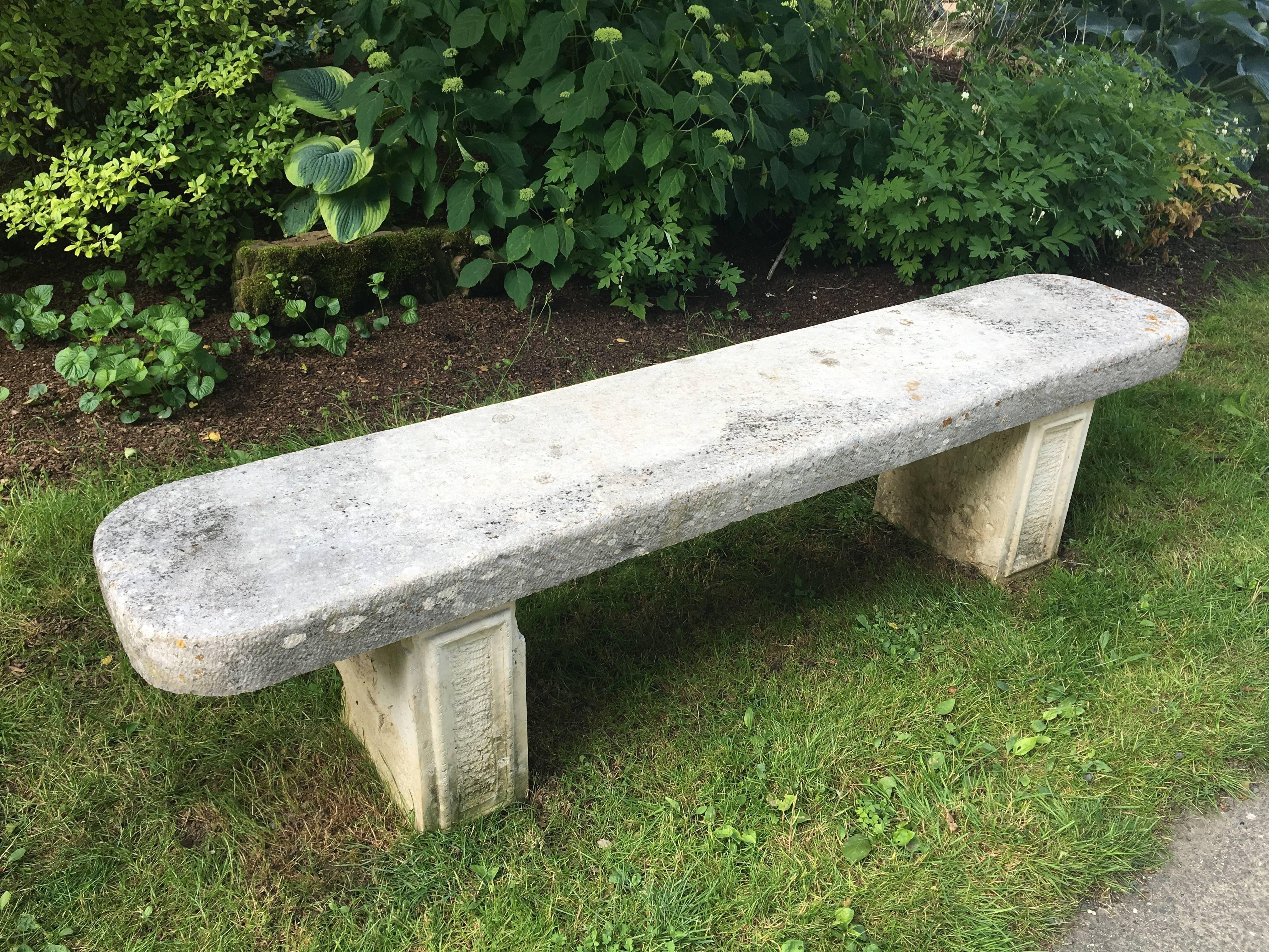 What a beauty! Hand-carved from limestone and with lovely rounded edges on the seat, this garden bench has a nicely-weathered surface and is in very good antique condition. The two supports have rectangular incised detail that are
