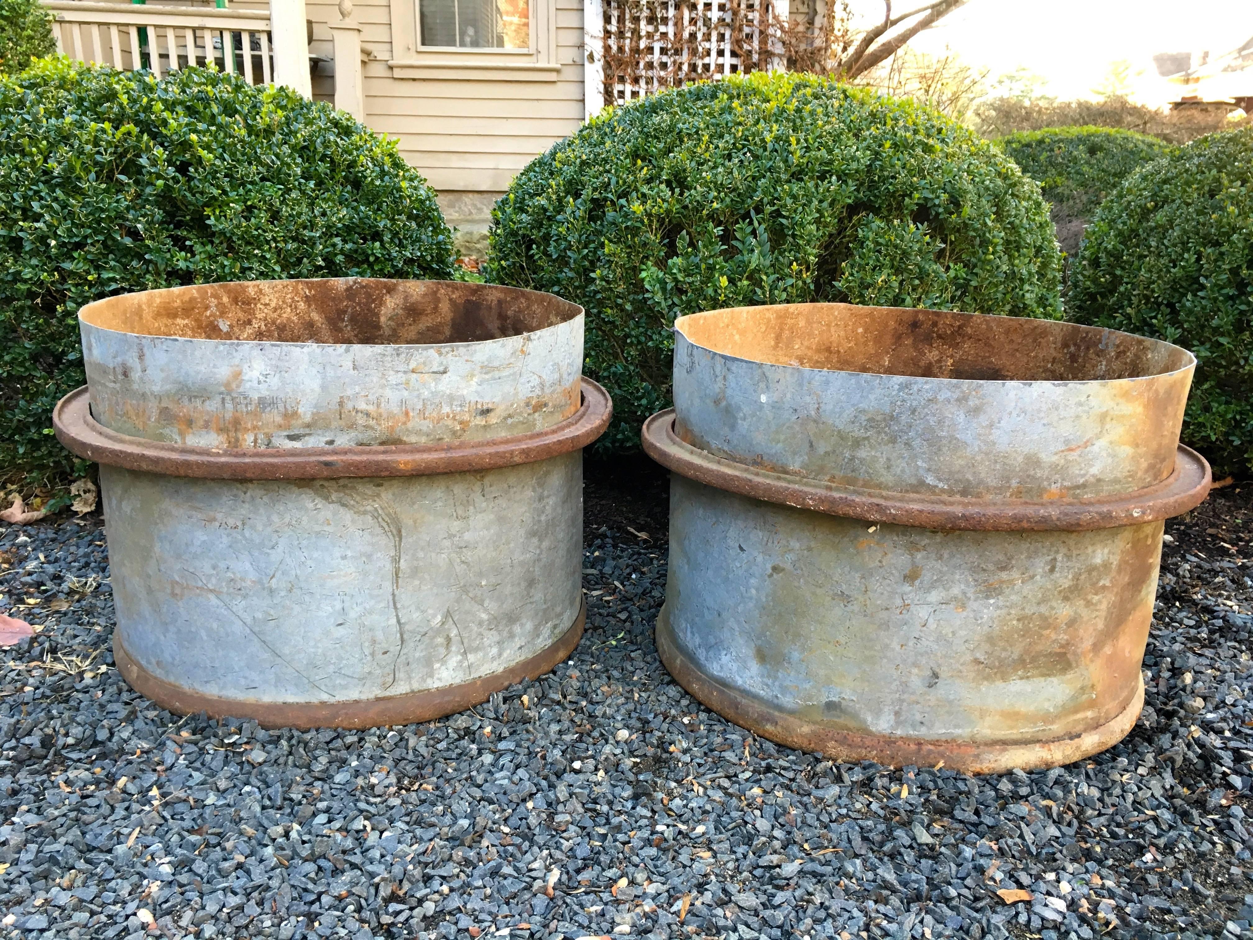 These heavy galvanized steel tubs with removable iron edging rings are the perfect choice for contemporary residential or commercial settings. Made in France by Naphtachimie, an Industrial company founded in 1949, these tubs date to the 1950s.