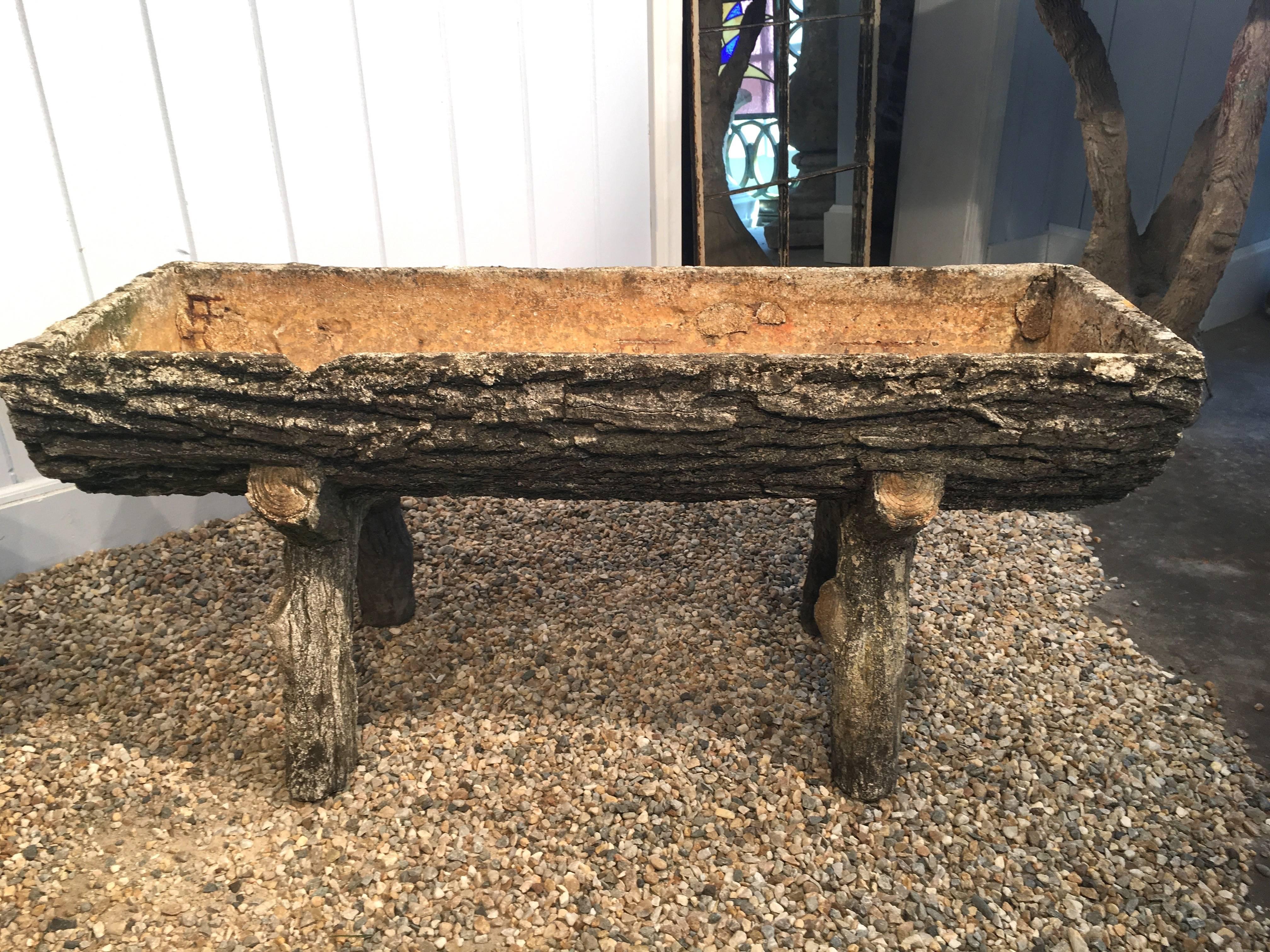 We see so much reproduction faux bois out there that we thrilled to come across this authentic pair of planters that dates to the 1930s. A rare and pleasing form allows for profuse plantings and their height gives them enough oomph to make real
