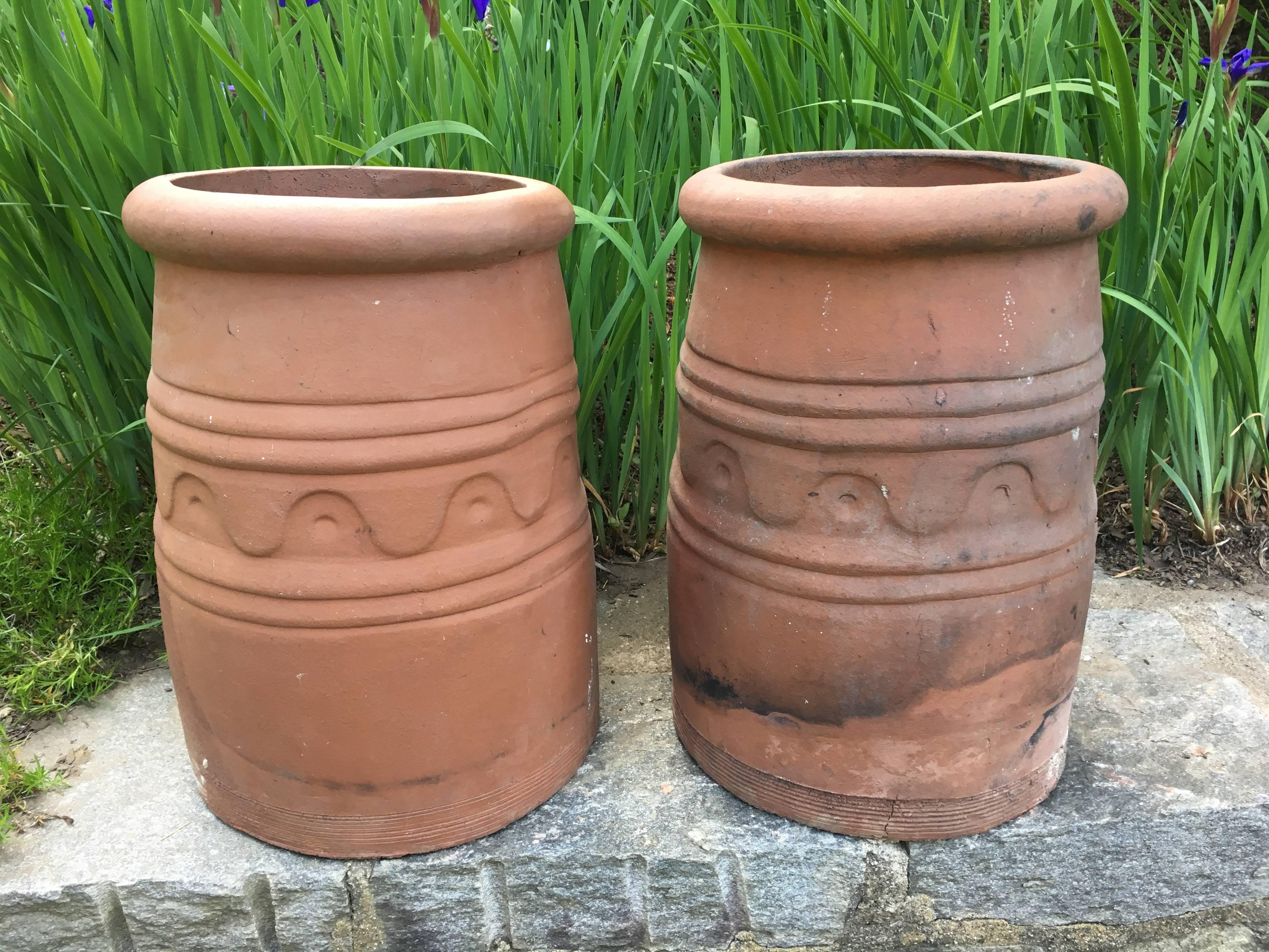 This is a great small pair of unusual Arts and Crafts chimney pots, made all the more utilitarian by the fact that they are perfectly sized to accept hanging baskets of cascading flowers from the nursery. We love them on either side of a garden path