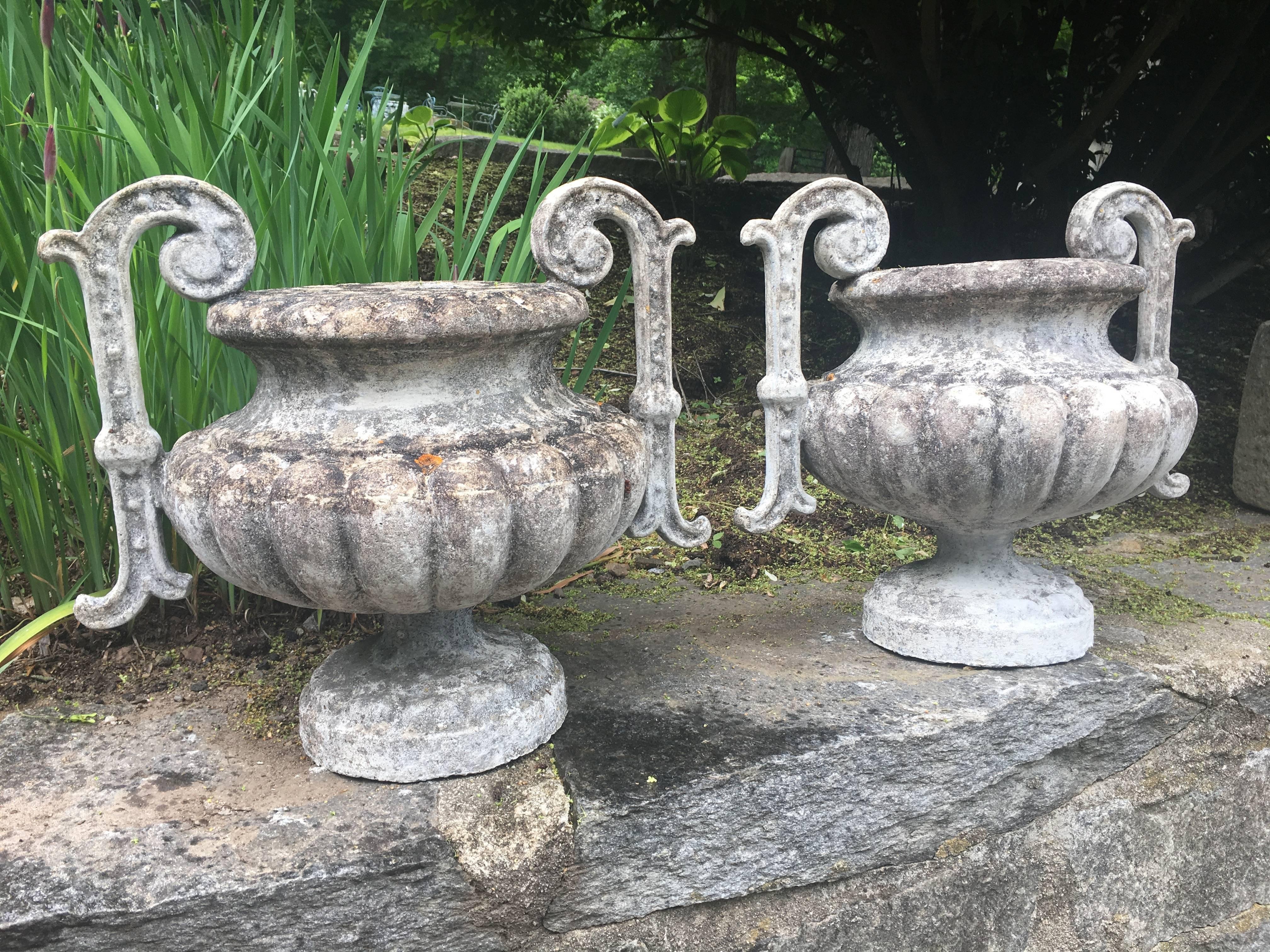 We have two pairs of these beautifully-lichened and mossy cast stone handled urn-form finials. Based on a famous form originally cast in iron by Alfred Corneau and Sons, these finials came from a chateau in Saint Émilion and date circa 1900. In