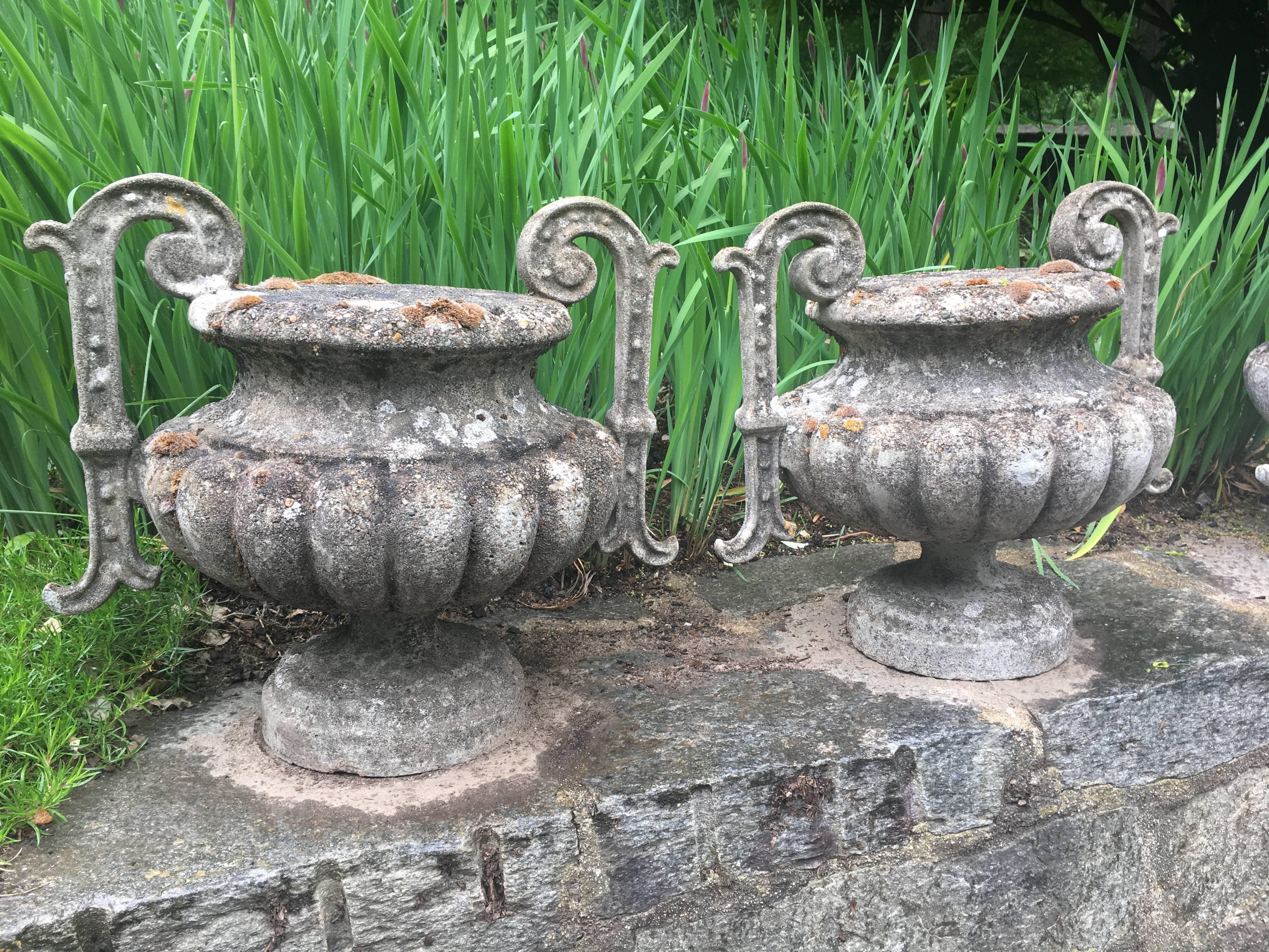 We have two pairs of these beautifully-lichened and mossy cast stone handled urn-form finials. Based on a famous form originally cast in iron by Alfred Corneau and Sons, these finials came from a chateau in Saint Émilion and date to around 1900. In