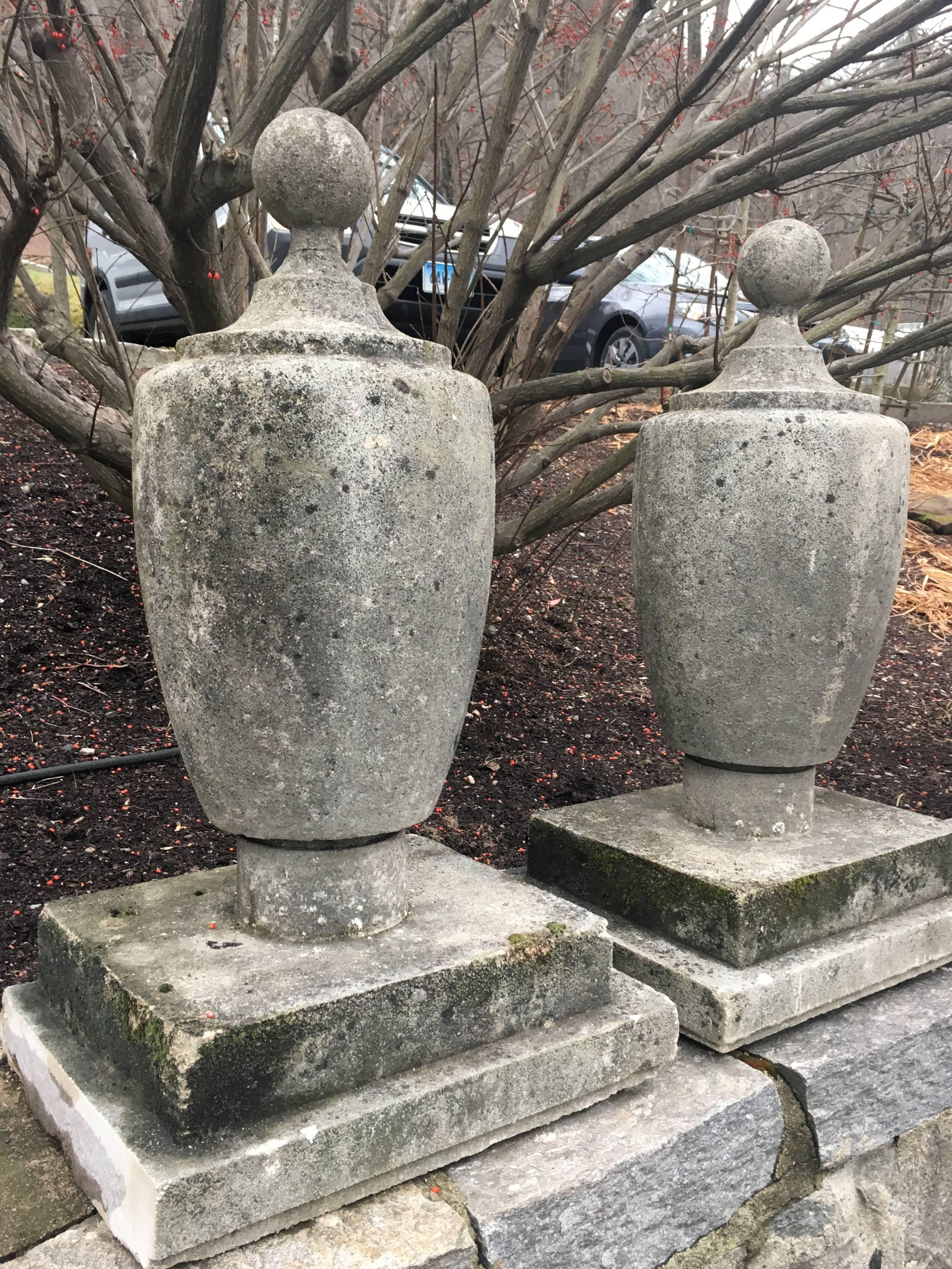 This stunning pair of well-weathered Art Deco cast stone finials have enormous presence and would make a real statement flanking the entrance to your home or driveway. When we bought them, they had uneven edges on the bases that we have since
