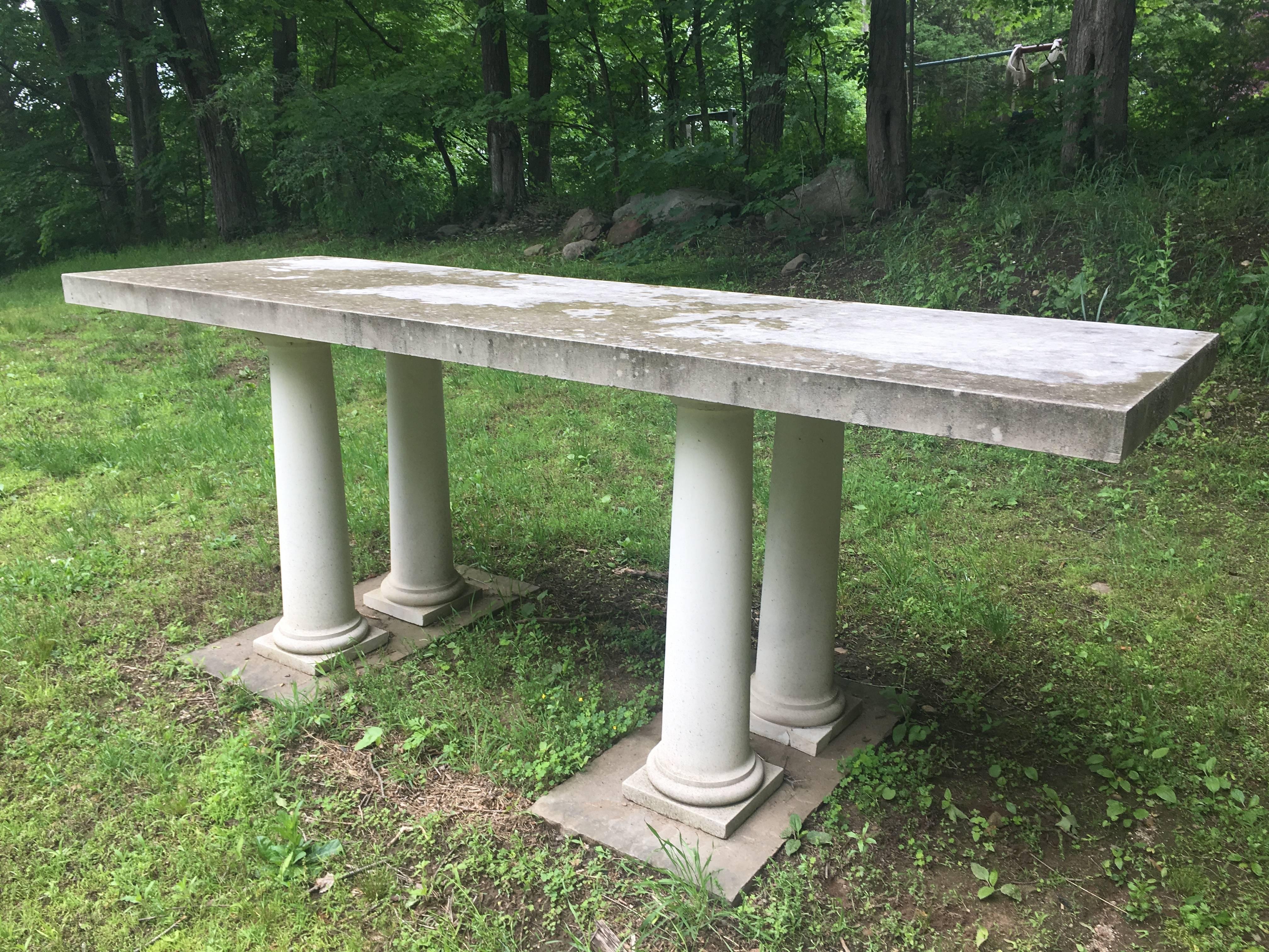 This magnificent table dates to around the 1960s and comprises a single Portland Stone slab top that is over 3 inches thick and four original Tuscan-style column supports. We think it may have originally been an altar! The top is in perfect