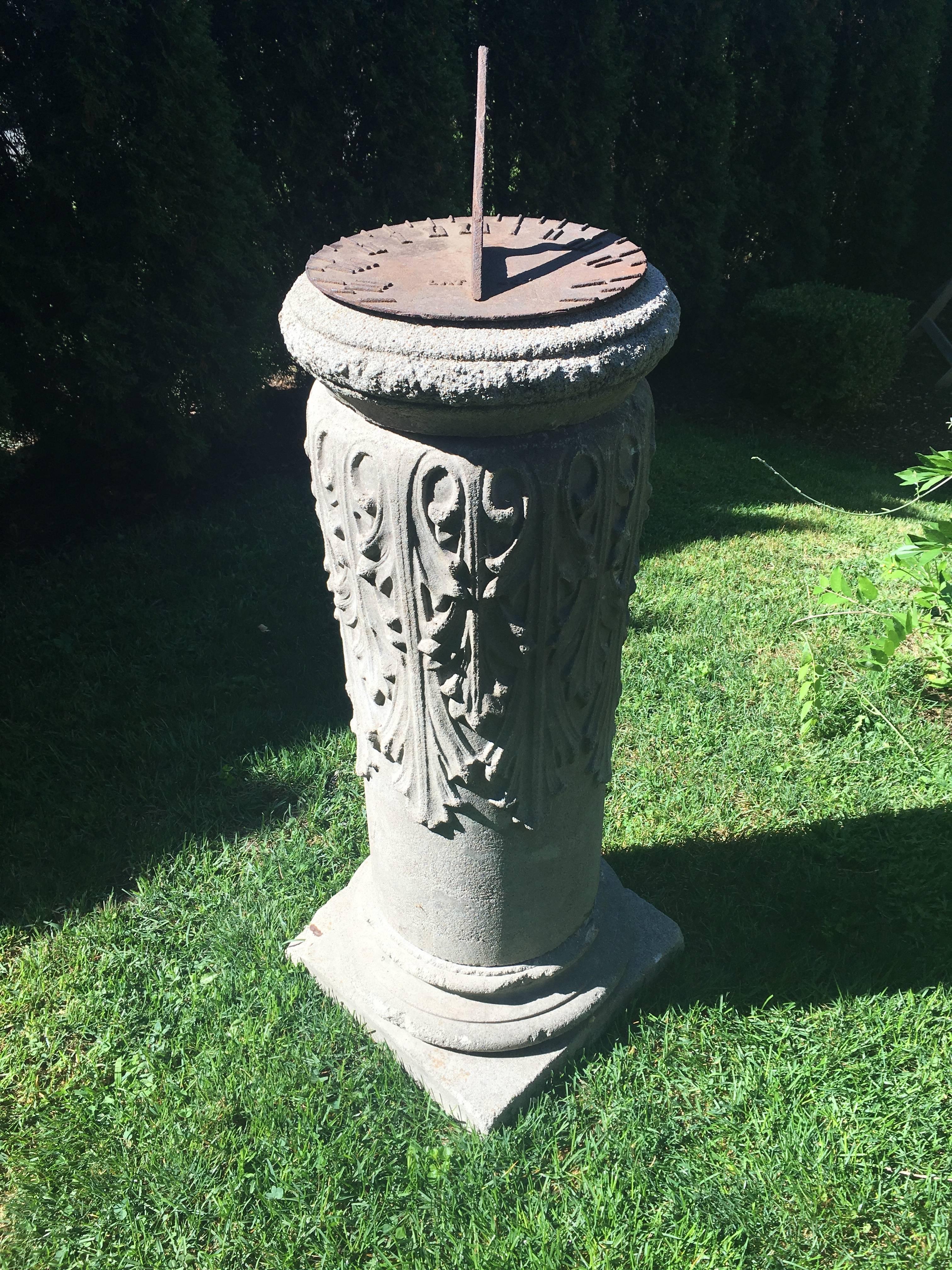 This lovely and unusual form sundial in four parts is a marriage between an American cast stone pedestal with anthemion leaf decoration and a late 19th century American cast iron sundial plate, marked 40 degrees latitude (just about New York time).