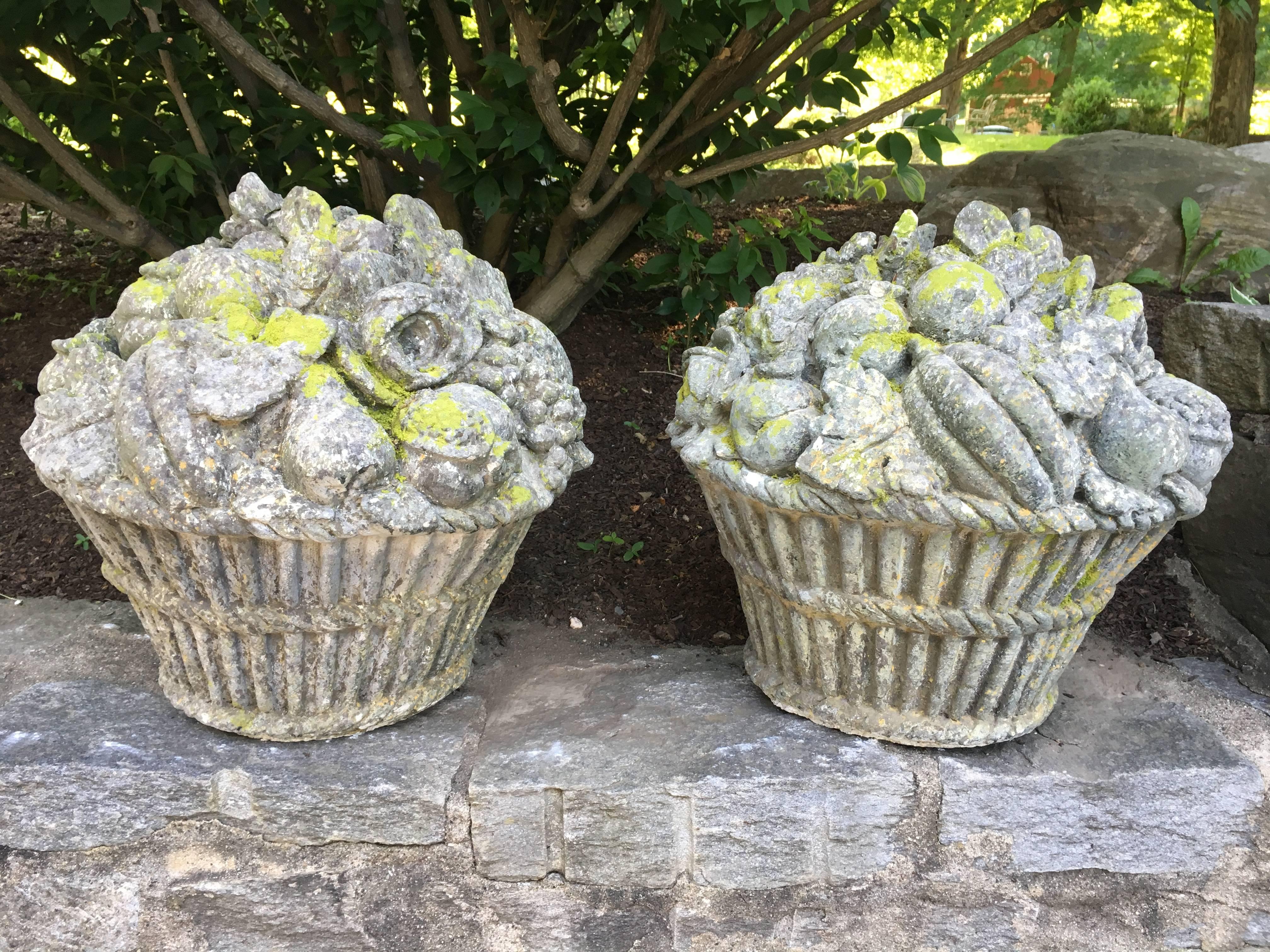 These cast stone fruit and flower baskets have very little age, but are charming and well executed nonetheless. With a plethora of grapes, bananas, apples, pears and leaves, they would make a wonderful addition atop a stone wall flanking the