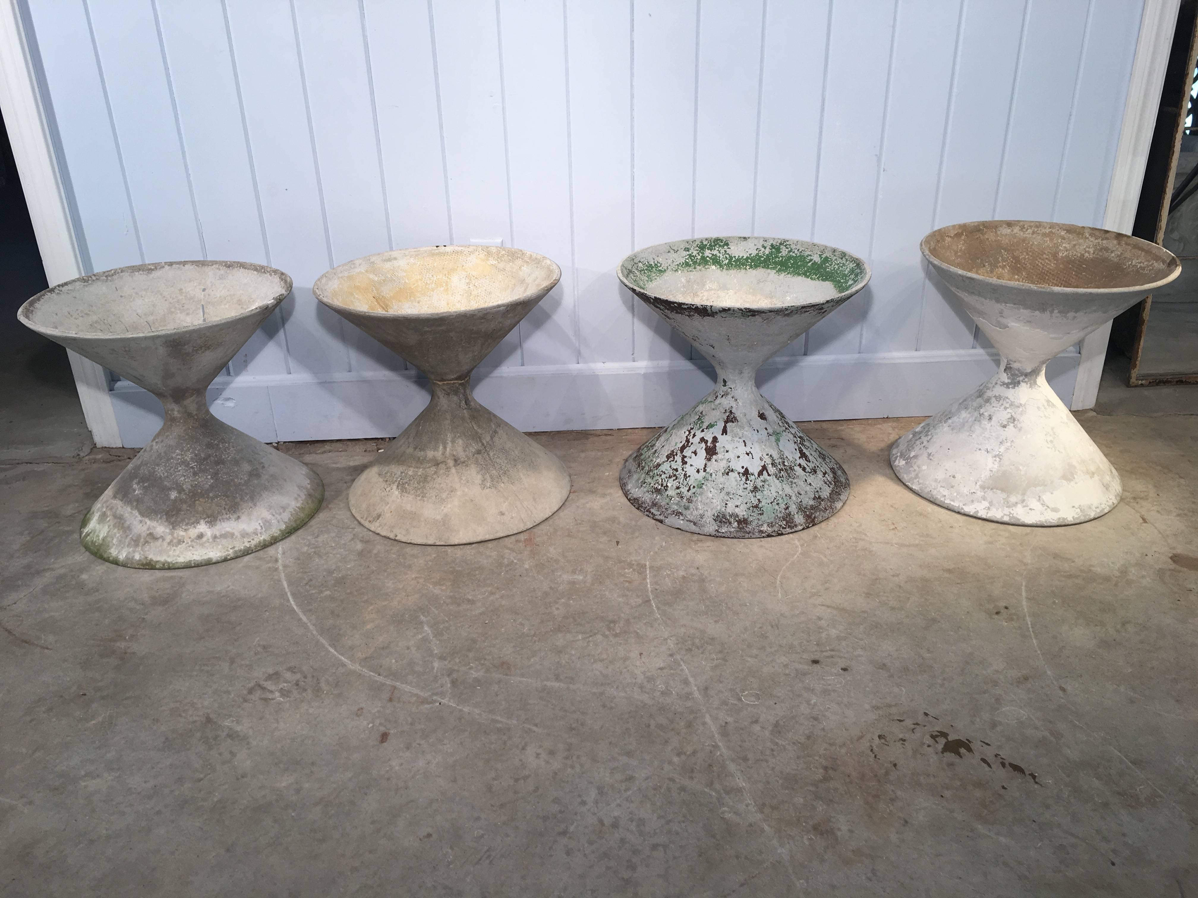Designed by the iconic Willy Guhl and Anton Bee in the early 1950s, and made of fiber cement by Eternit, AG, these planters sport various shades of old, weathered paint and are in excellent condition. Grouped together, they make a stunning statement