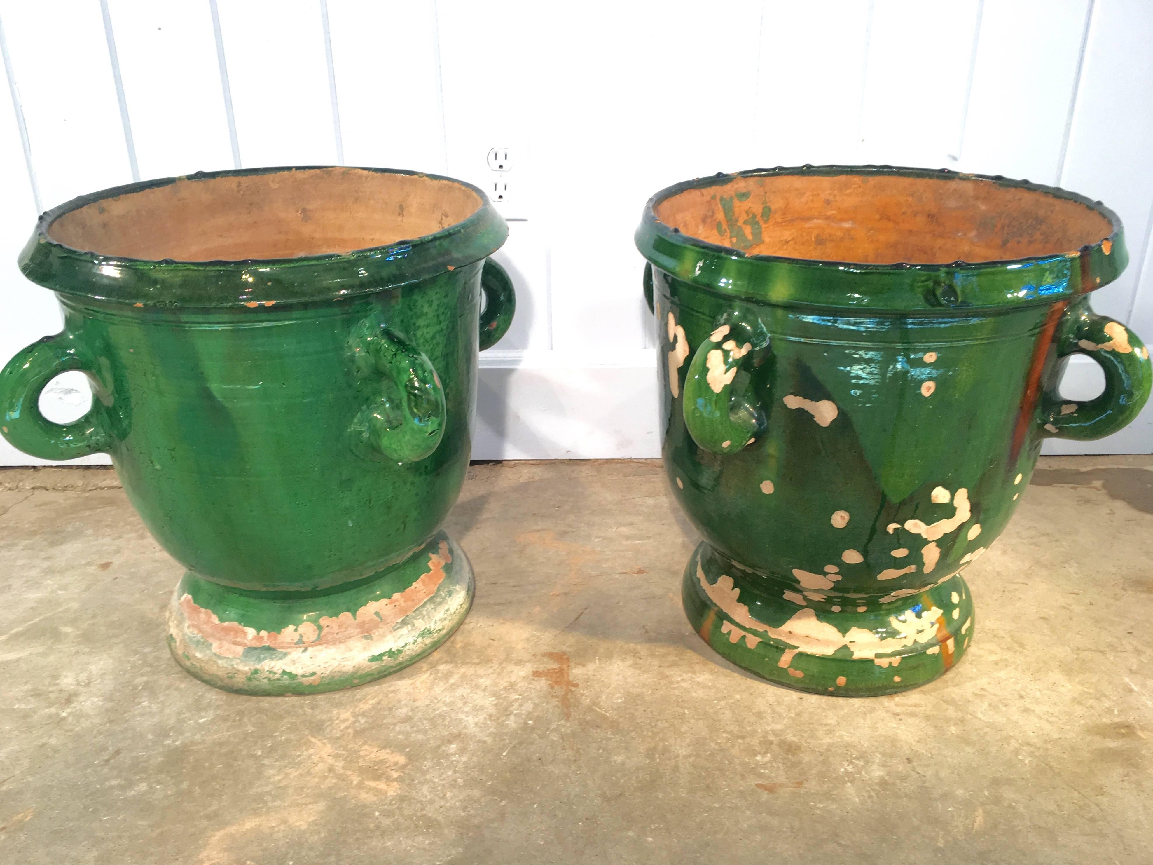 This pair of small handled Castelnaudary pots are amazing for their intense green glaze that is completely intact on one pot and largely intact on the other. They are best paired with our single larger Castelnaudary pot (CPO 1040) or large Anduze