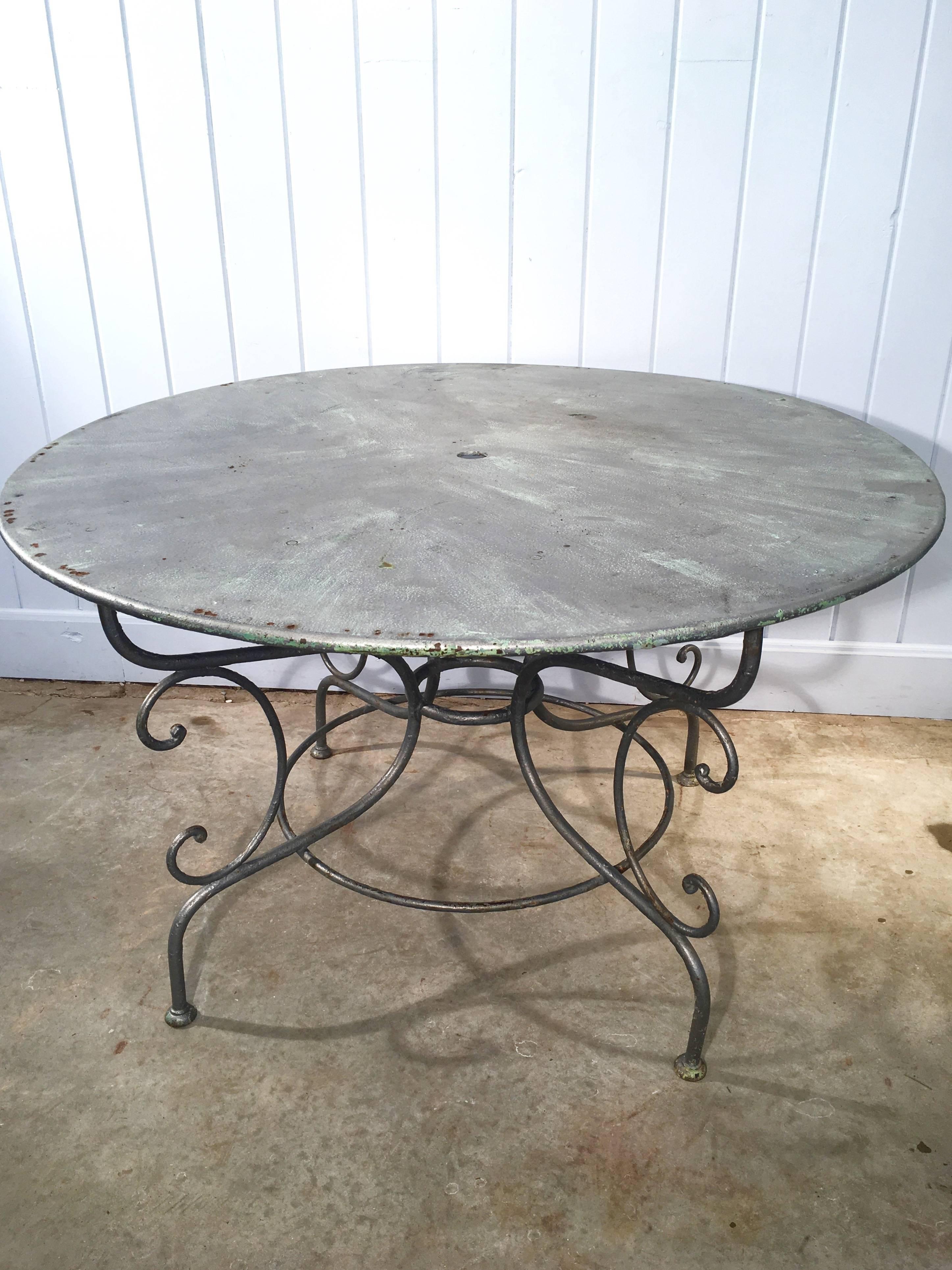 We love scrolled-base French garden tables and this one does not disappoint. In a pale, somewhat muted and translucent silvery paint, it has undertones of green and can be left as is or stripped and powder-coated so you never have to worry about