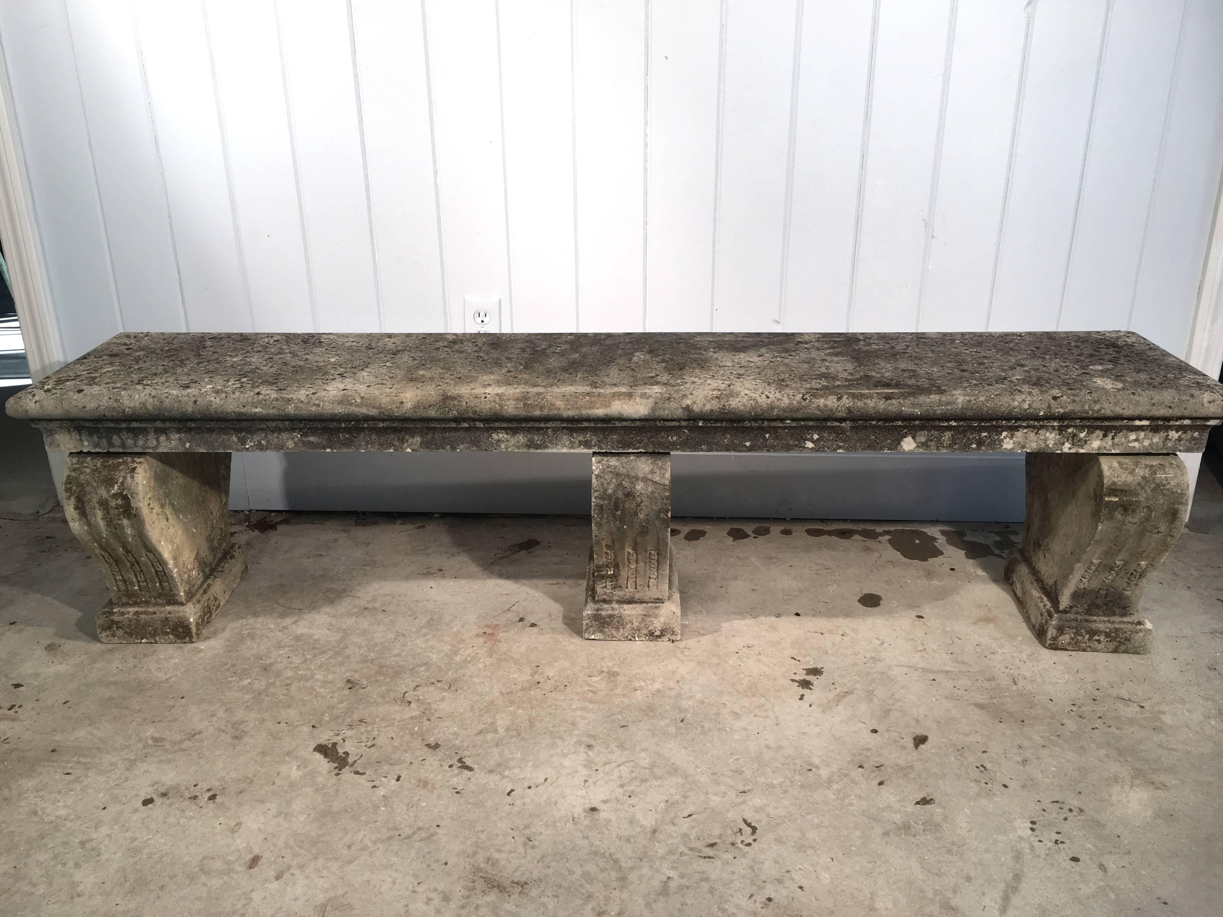 Long carved stone benches are difficult to come by, especially in superb condition. This limestone one is particularly lovely and has a beautifully-weathered patina and three supports. It would be stunning placed at the end of a long allée of