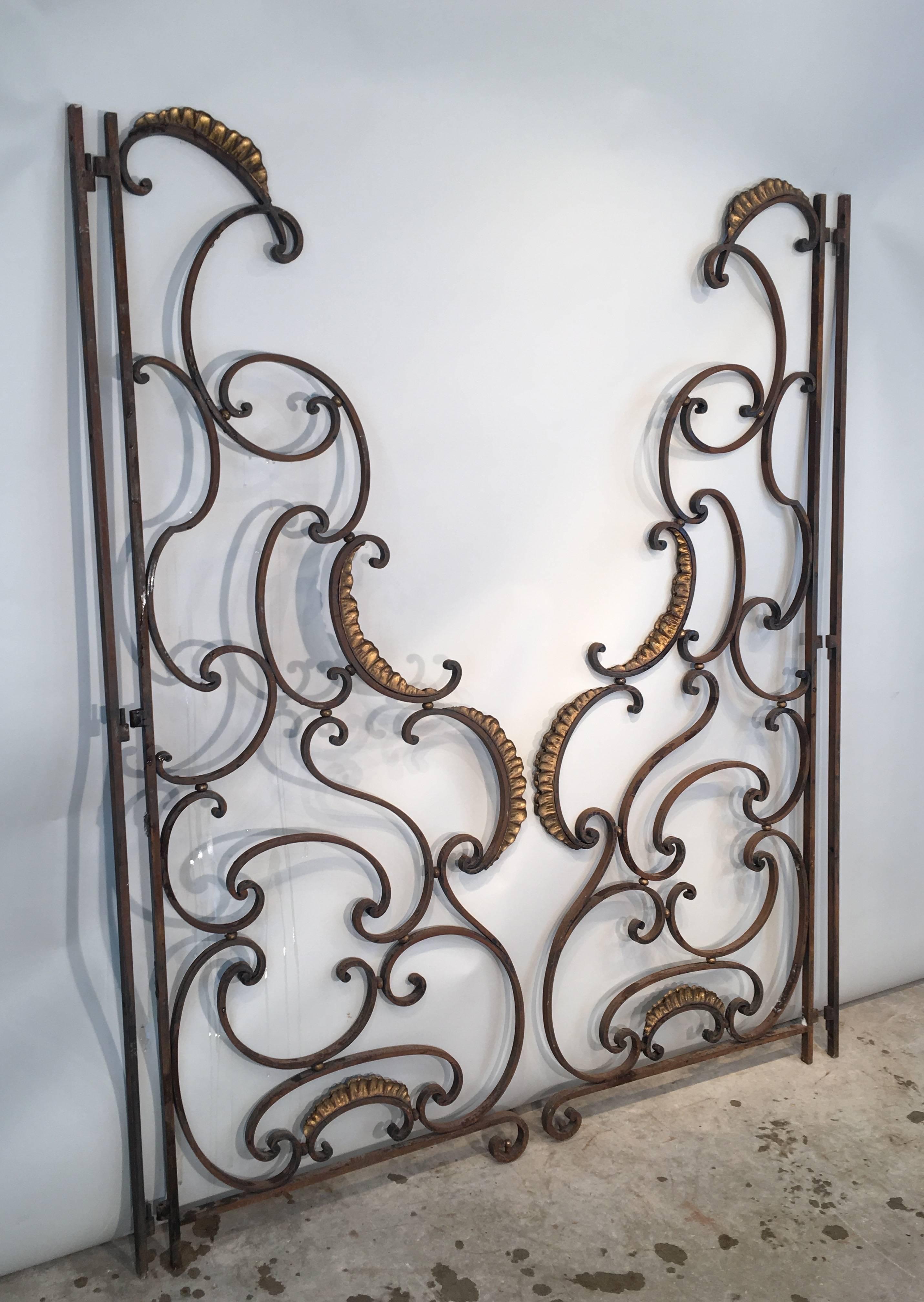 This glorious pair of wrought iron balcony dividers were originally used at both ends of a balcony to provide privacy from neighbours. This pair, however, could also be used as swinging or fixed gates, inside or out. With their intricate design and
