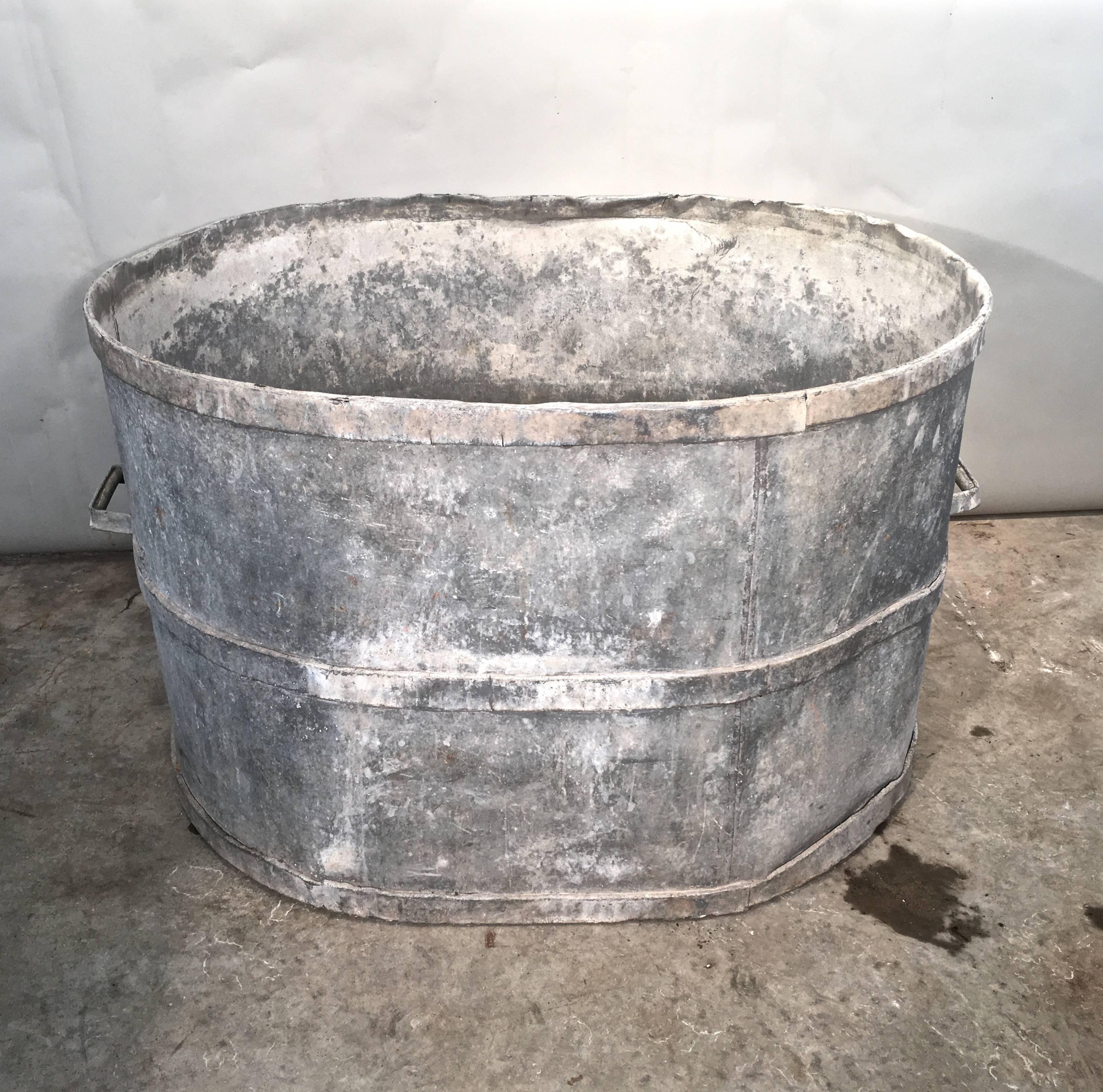Old, authentic French zinc planters are very difficult to find and this one is a beauty! Sufficiently large to hold an enormous display of flowers or grasses and sedum, this piece can also easily be converted into a fountain. In very good condition