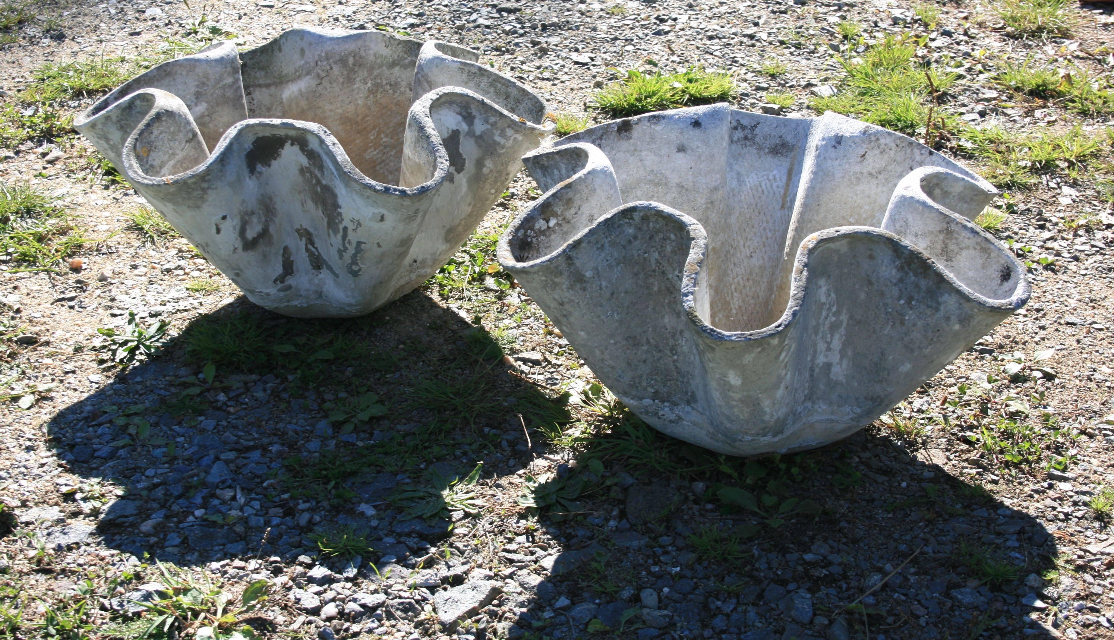 Willy Guhl designed his famed "Biomorphic Planters" in two sizes and these are the smaller of the two. They sport a wonderful weathered patina with traces of original white paint and bits of moss and are in excellent condition (excepting a