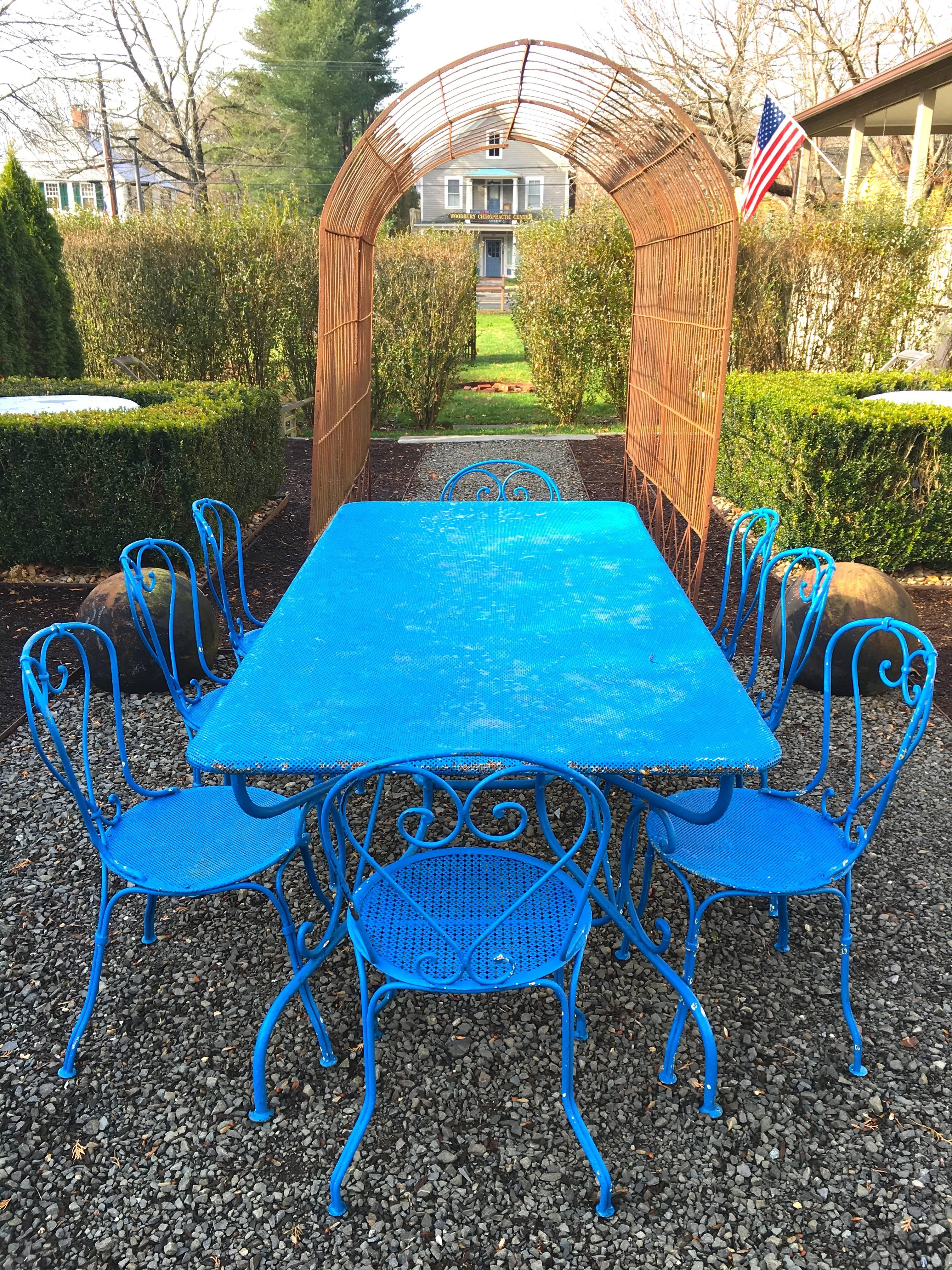 We adore this bright French blue in the garden, especially with a backdrop of dark green boxwood or arbor vitae and this nine-piece set is wonderful! With six matching side chairs and a pair of slightly-different end chairs, all with curved,