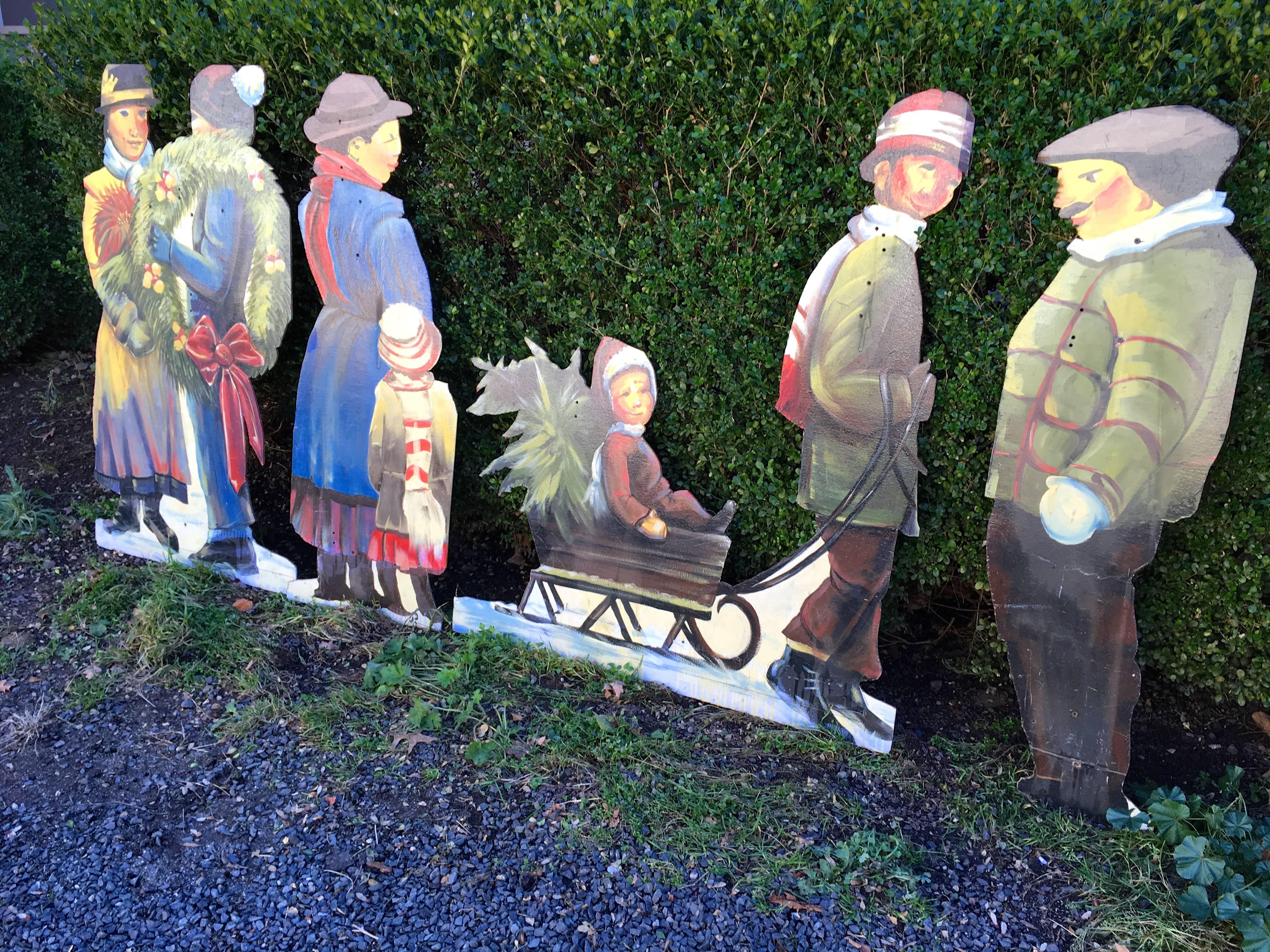 This collection of four hand-painted, large holiday figures on plywood depicting a group of villagers preparing for Christmas is rare and choice. The painting is extremely skilled, very colorful and the style of the figures is turn-of-the-century
