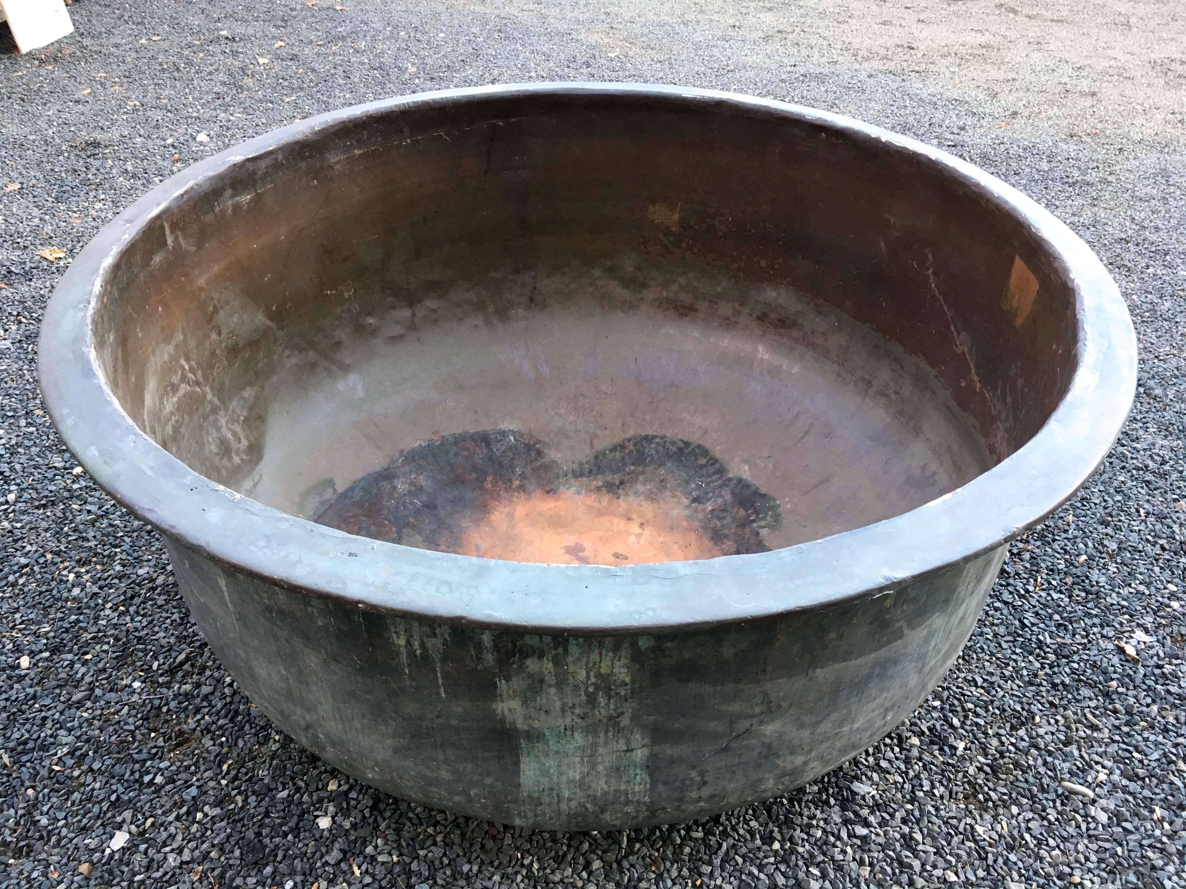 Now this piece is truly unusual! At 5' diameter and with impeccable naturally-verdigris surface, this heavy copper vat comes from Provence and was originally used to make cheese. It's in great condition, with a very minor split to the rim (photo #4)