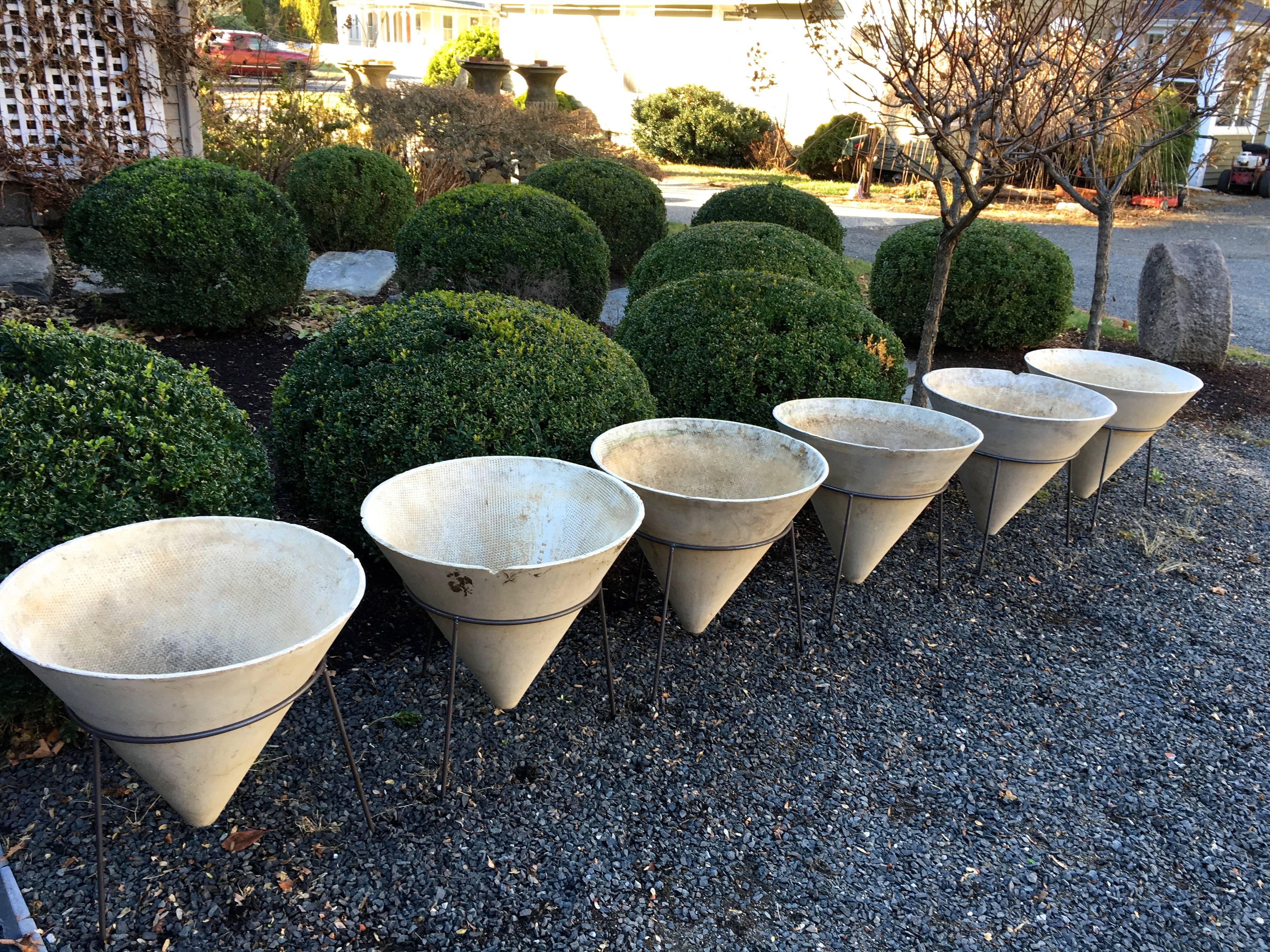 We were very fortunate to source these numbered Willy Guhl conical planters in all natural and unpainted surface and have had 3-legged contemporary steel stands made for them. We have painted the stands in a satin black finish that resembles
