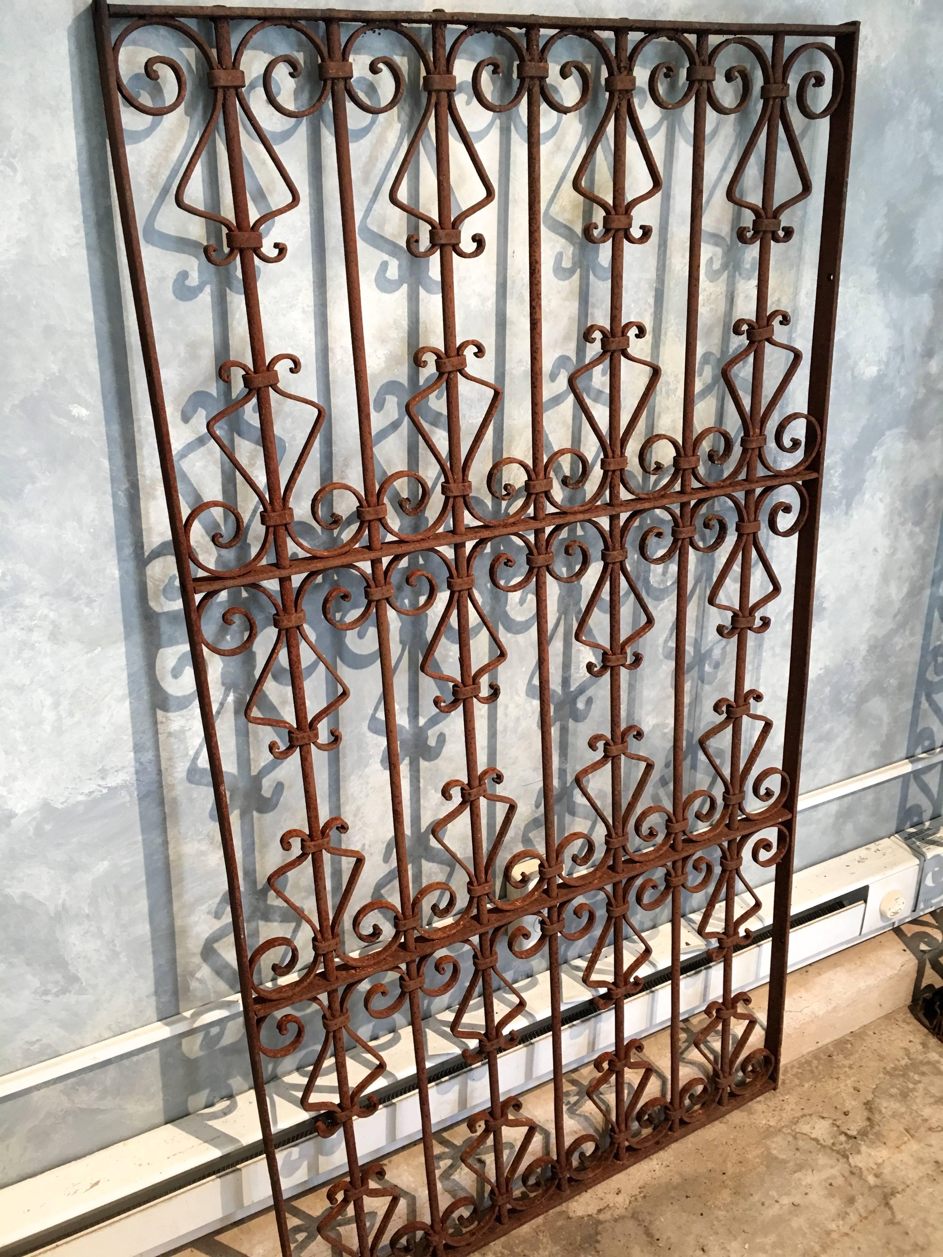 This lovely hand-wrought iron grille was not originally intended as a gate, but could easily be transformed into one with hinges by our talented blacksmith. It is in perfect structural condition, with surface rusting, and, of course, can be