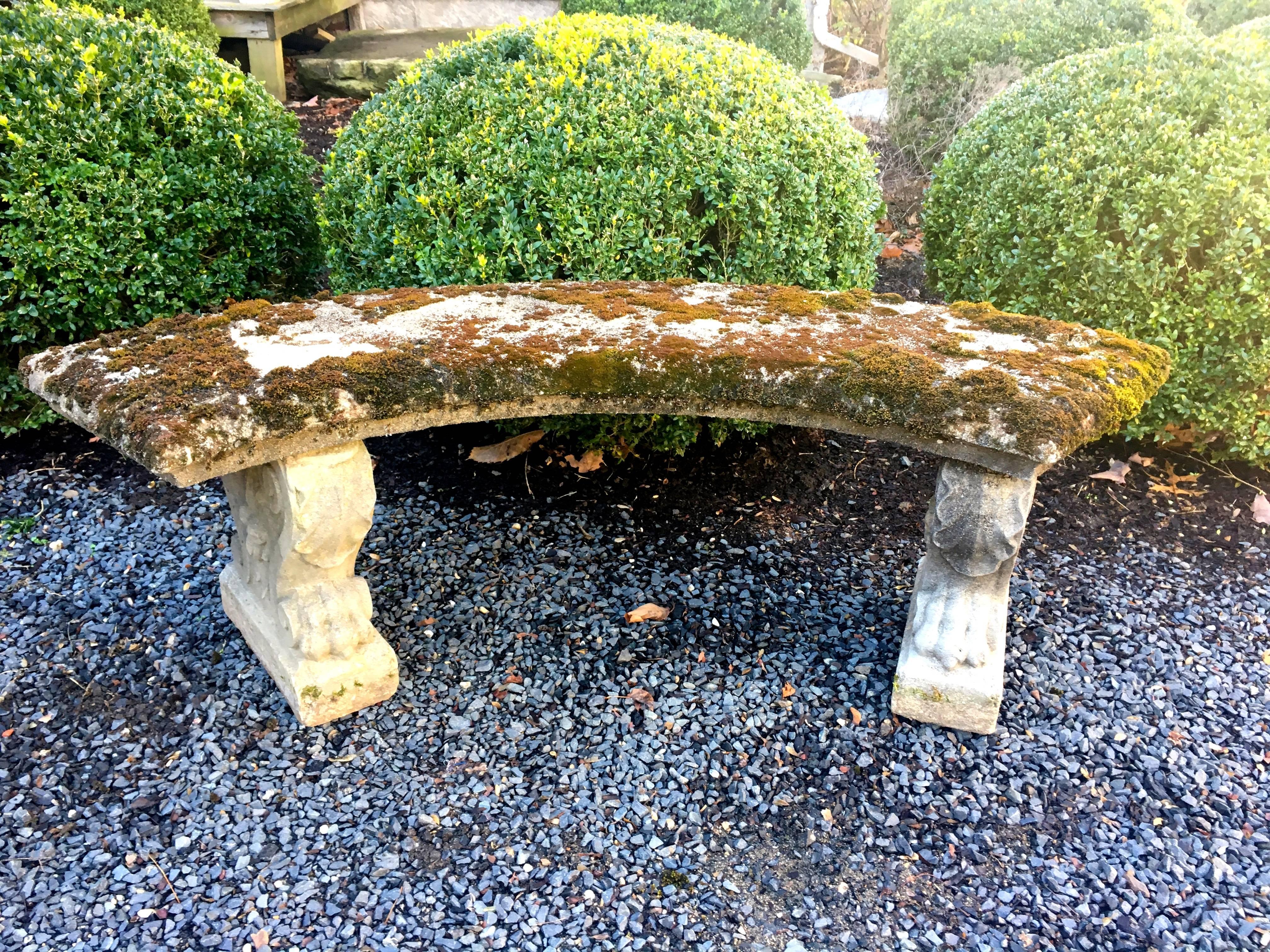 What a classic! This nicely-cast curved bench with lions' paw feet and volute supports is covered with luxuriant moss that will continue to thrive and grow when placed outside in a shady and damp area. In excellent condition, with only a very small