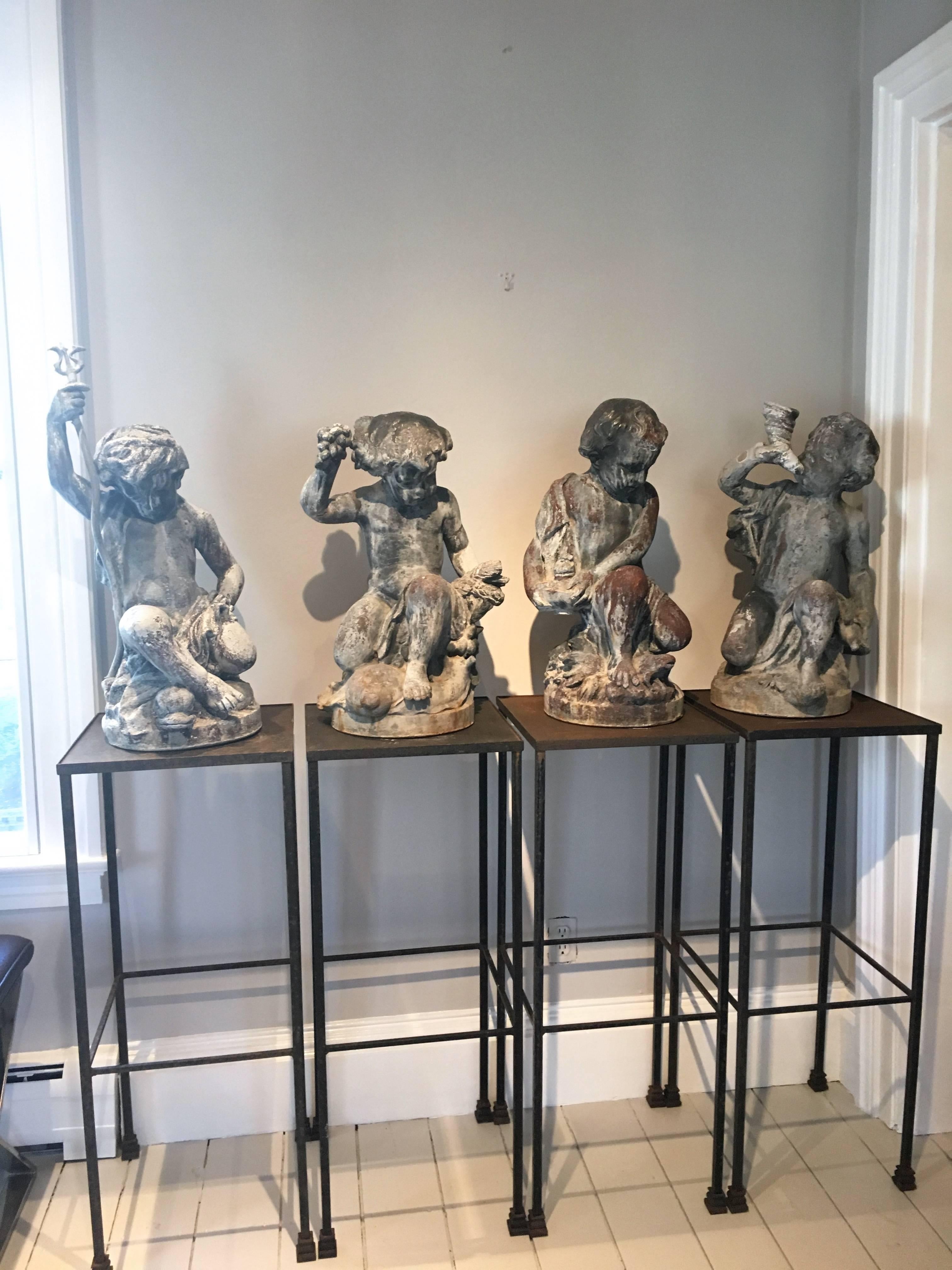 This complete set of The Four Elements by John Parish (J.P.) White, is the most rare and desirable group of garden statuary produced between 1896 and 1938 by the Pyghtle Works in Bedford, England. Representing (from left) Water, Earth, Fire, and