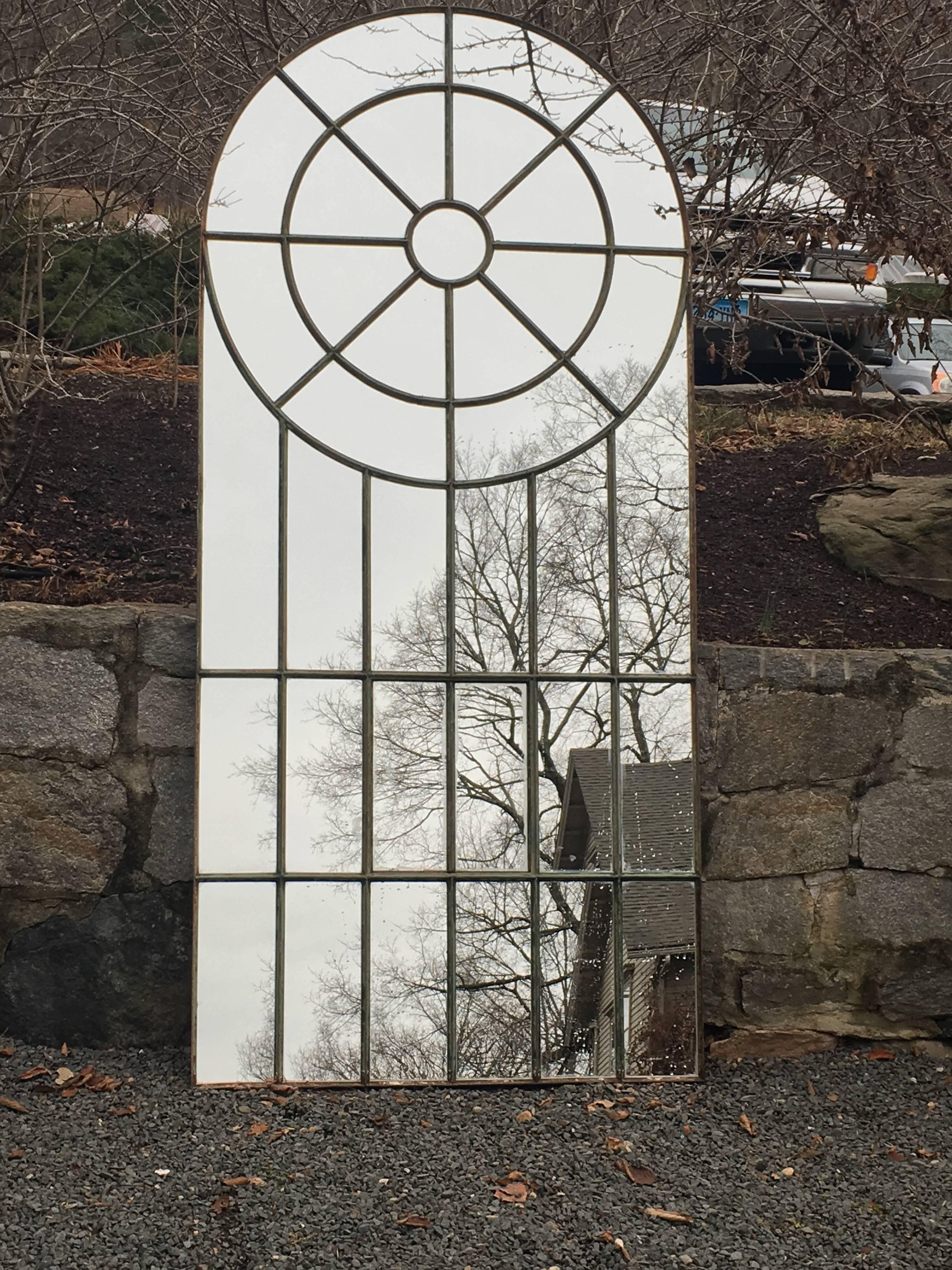 This very large cast iron mirror frame has been transformed into a splendid focal point with the addition of new, hand-glazed mirrored glass. Dating to the late 19th century, and made by the famous English window company, Crittall, it sports its