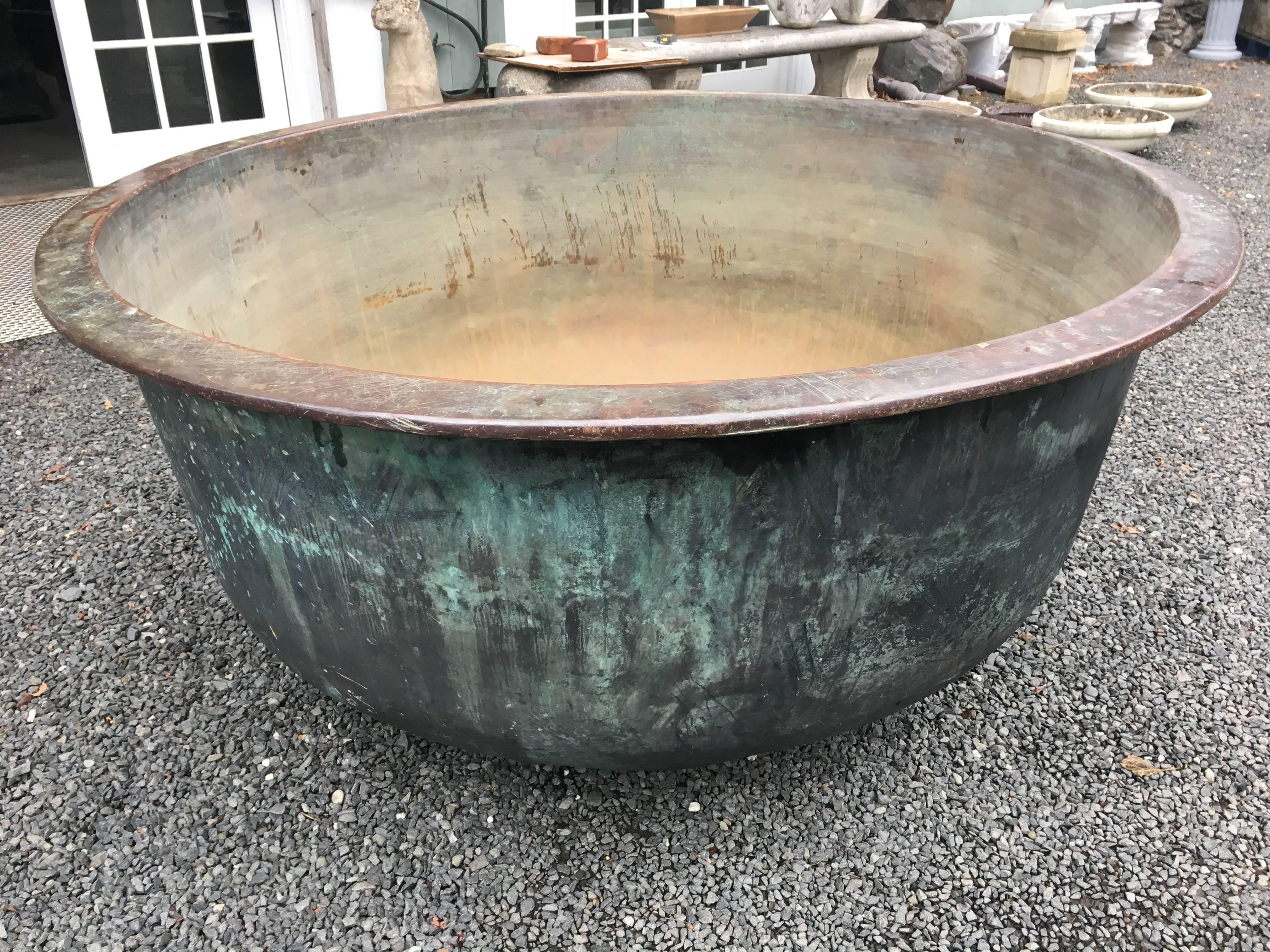 Now this piece is truly unusual! At over 5.5 feet in diameter, and with impeccable naturally-verdigris surface, this heavy copper vat comes from Provence and was originally used to make cheese. It's in great condition, with a very minor fissure to