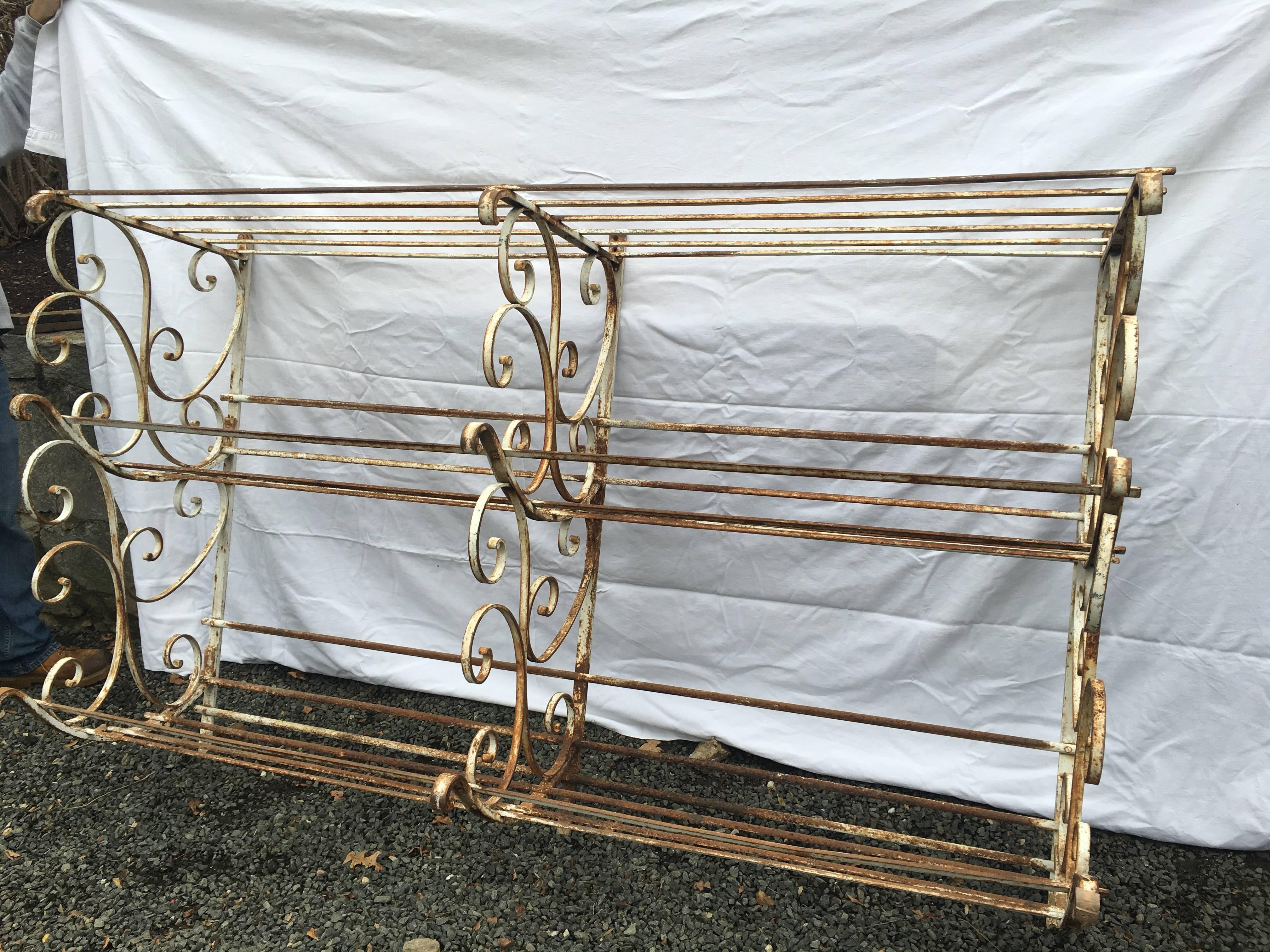 What an unusual and rare piece! Straight from a boulangerie in the Southwest of France, this hand-wrought iron rack in original, worn white painted surface with some rust was originally used to store baguettes. We think it would make an amazing