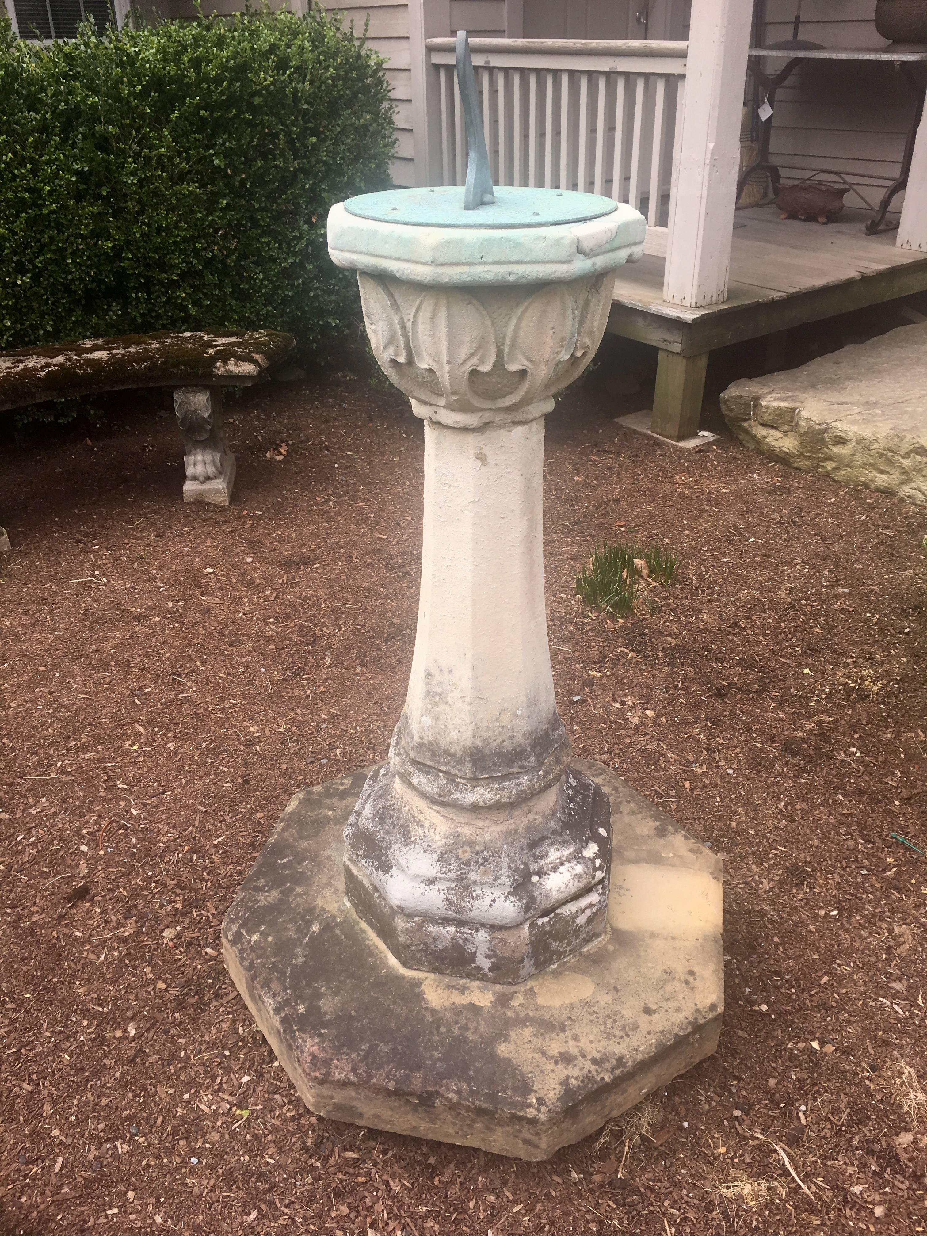 This large and impressive Arts and Crafts sundial in three parts is the best we`ve seen in a good long time. Hand-carved from a heavily fossilized stone, it appears to have been married to an octagonal carved sandstone base and we believe the bronze