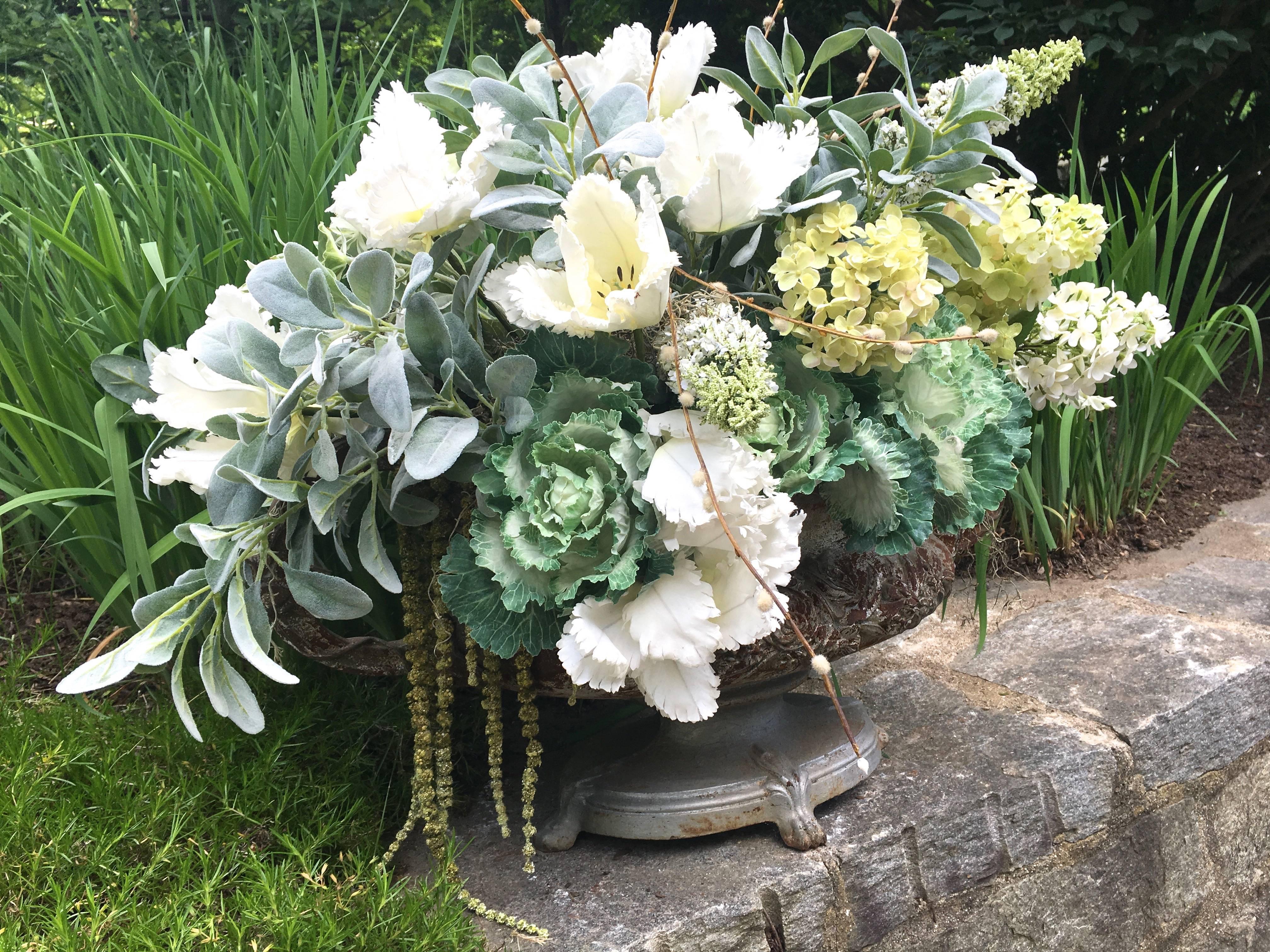 This very large tabletop cast iron urn has a lush romantic look, crisp detailed casting, oval base and highly-decorative handles in old silver paint. Filled to overflowing with fabulous faux flowers by Sari Weatherwax in shades of grey, green and