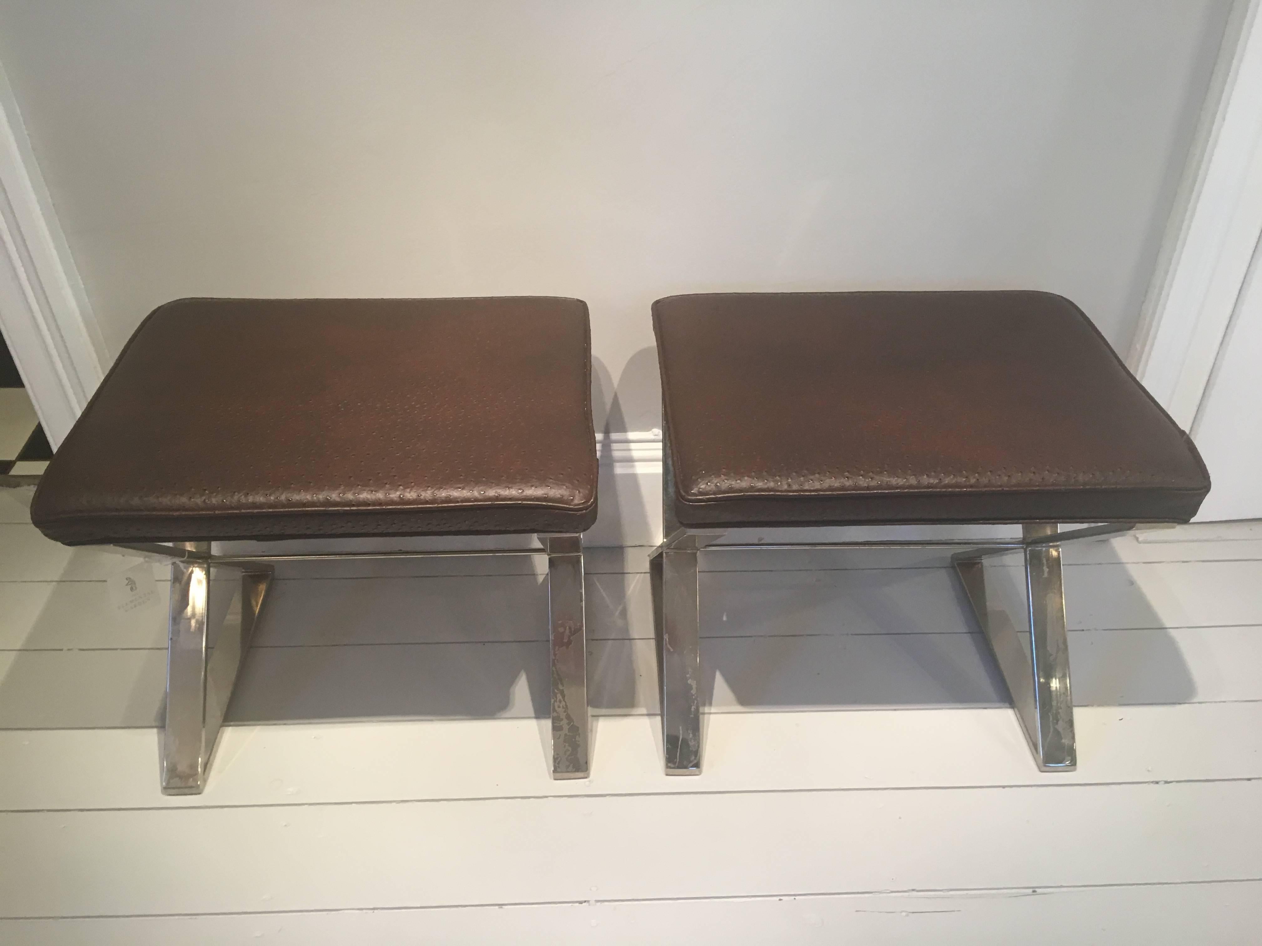 These polished chrome X-based stools, newly reupholstered in realistic faux chocolate brown ostrich are stunning. Place all four around a low table or a pair at the foot of a bed for a contemporary statement. Minor scratching to the frames and a few