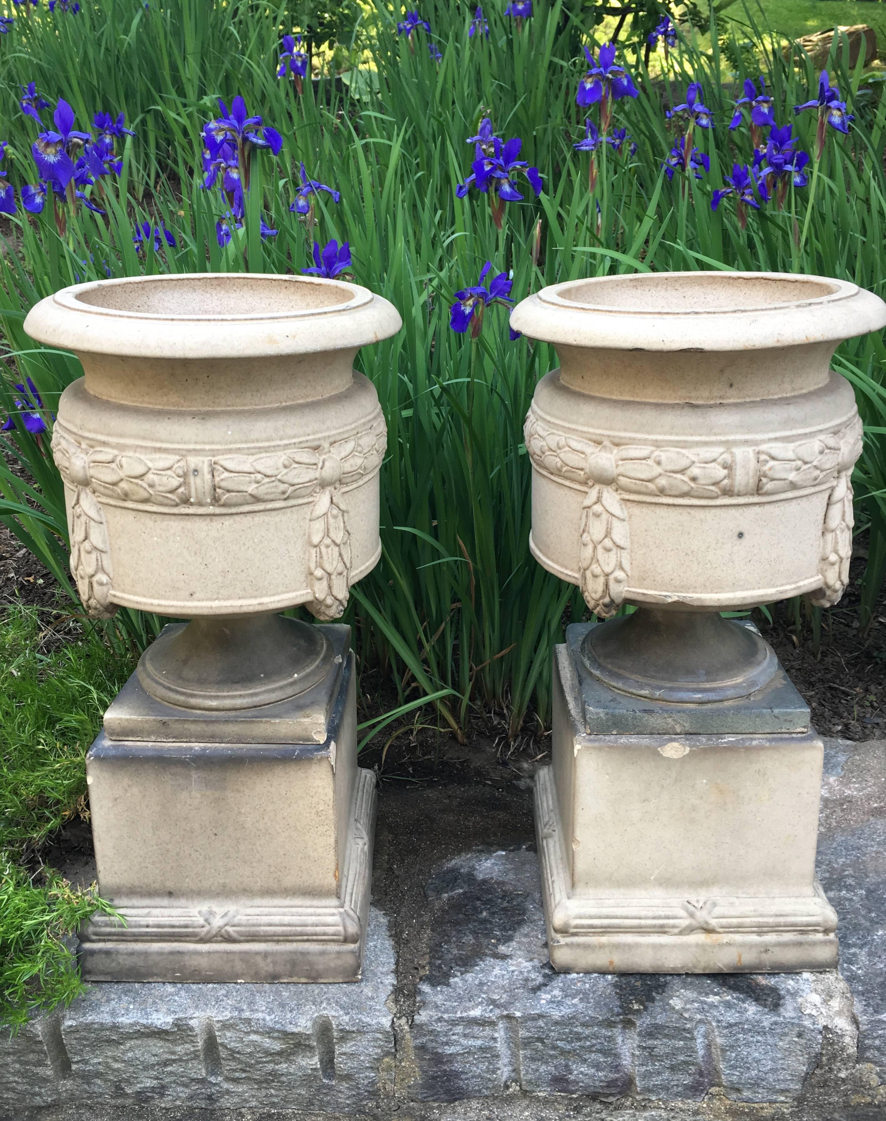Signed inside the bases by the Leeds Fireclay Company (LEFCO), these urns in three parts have a rare form and their original plinths. Beautiful laurel wreath swaging decoration. Gorgeous on their own or potted and placed inside or out.
Fireclay is