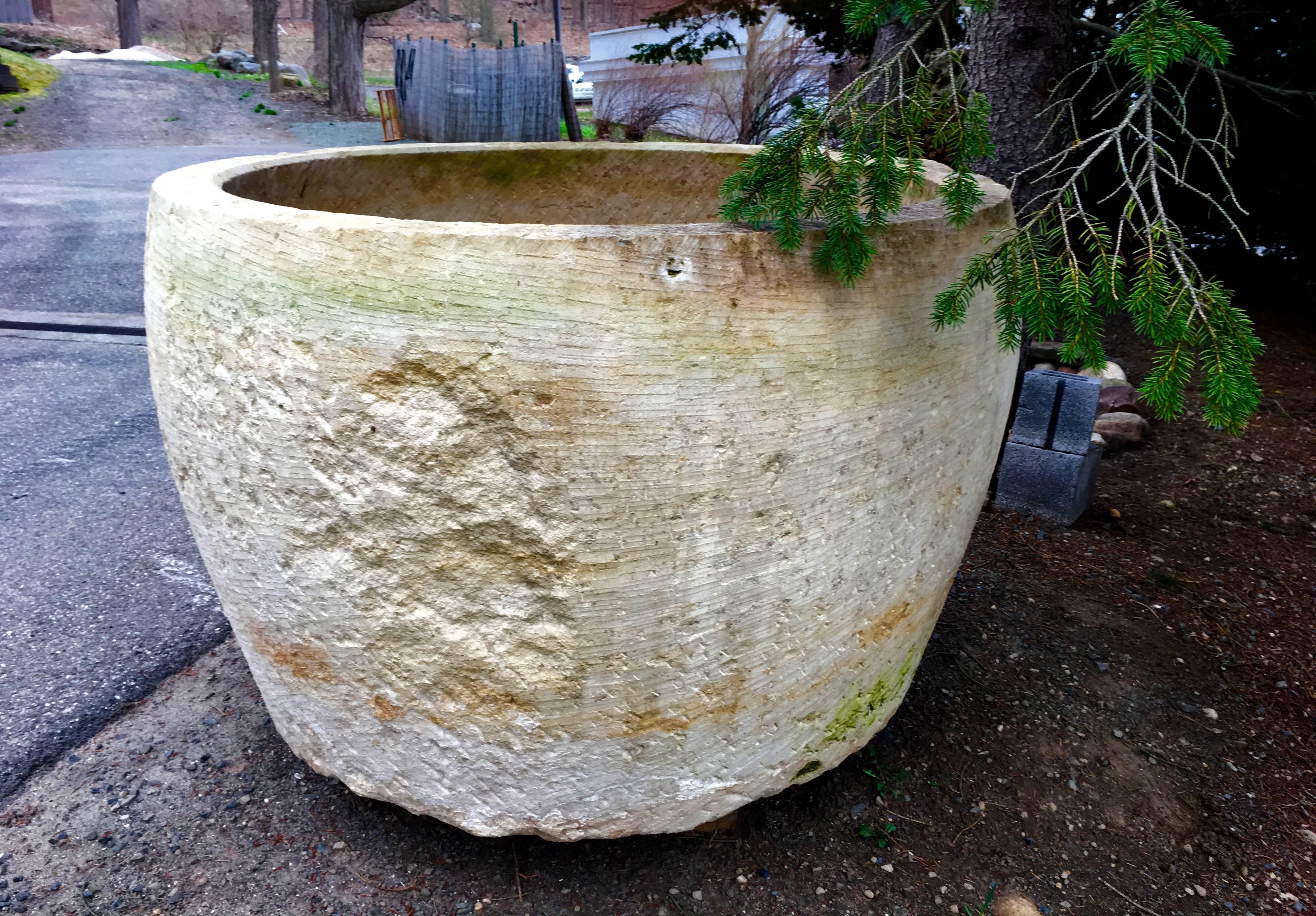 One of the most exceptional finds of our French buying trips, this enormous round trough is hand-carved from a soft limestone known as Pierre de Deux Sevres. Its warm honey color and light weathering are most appealing and it would be stunning as a