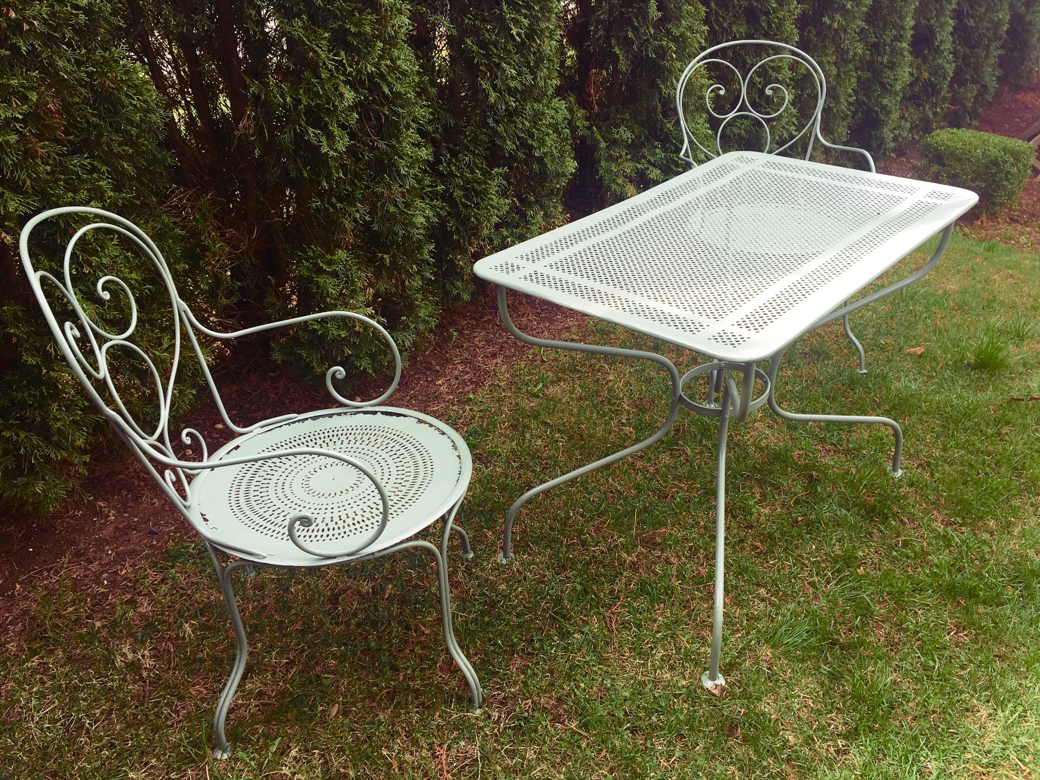 We found this lovely pair of chairs and table in Provence, but the paint was hideous, so we've had the set sandblasted and powder-coated in a soft neutral greyish-green. The table dates to about 1910 and measures 38.5