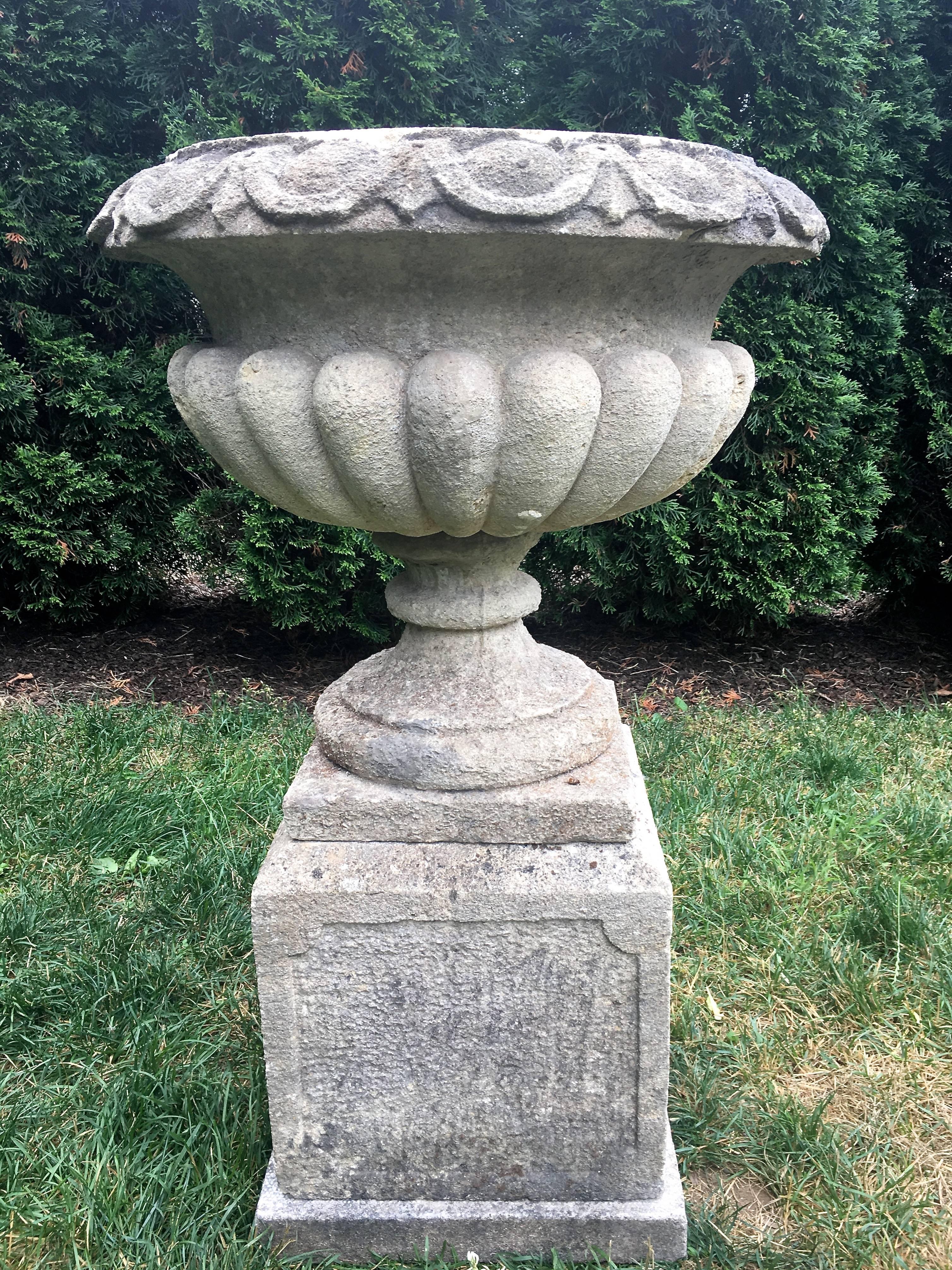 This is a wonderful example of mid-19th C stone carving in France. With a deeply-incised and stylized egg and dart rim, semi-lobed bowl, and subtle recessed panels on the base, this urn will be perfect as the center focal point in your herb or rose